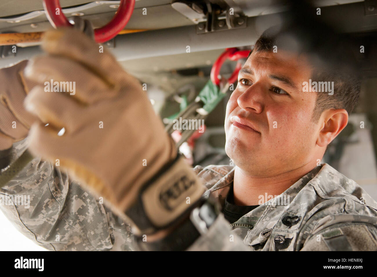 Fort Hood Air Assault instructor inspects safety equipment of a UH-60 ...