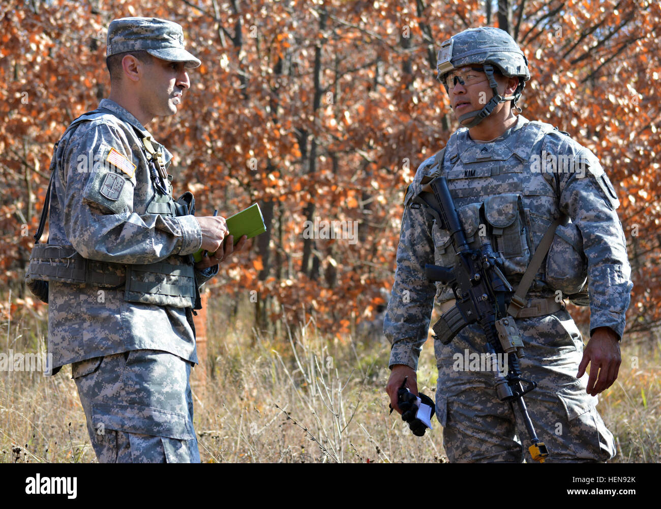 U.S. Army Staff Sgt. Joel Celona, an East Boston, Mass. native and a cadre member with the 7th Noncommissioned Officers Academy, conducts an after action review with U.S. Army Cpl. Hee Beom Kim, a Joint Regional Detachment-East soldier and a native of Saipan, at the conclusion of a situational training exercise at Camp Bondsteel Nov. 22. Celona was one of five cadre members from the 7th NCOA who came to Kosovo from Grafenwoehr, Germany, to run the Warrior Leaders Course. (U.S. Army photo by Capt. Randy Ready, 4th Public Affairs Detachment) KFOR soldiers take the next step as leaders 131122-A-C Stock Photo