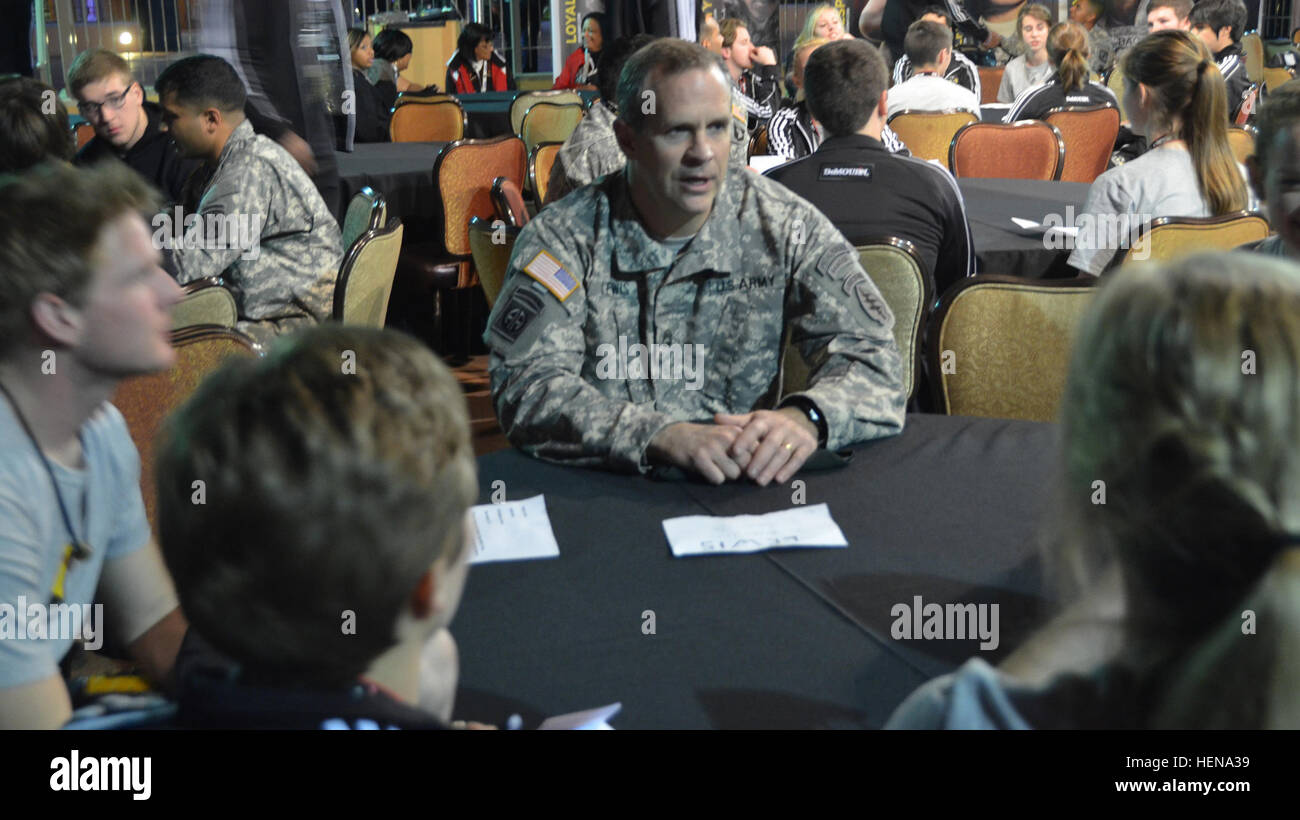 Sgt. 1st Class Matthew R. Lewis, a communications sergeant with the 10th Special Forces Group (Airborne) at Fort Carson, Colo., talks with high school students about his duties and experiences as an Army soldier during All American Bowl week in San Antonio, Jan. 1, 2014. Lewis and nine other soldiers from the U.S. Army Special Operations Command are attending the event as mentors to 90 of the nation's top high school football stars, along with 125 top high school marching band musicians and Color Guard members. Culminating the weeklong activities is the U.S. Army All American Bowl, the premier Stock Photo