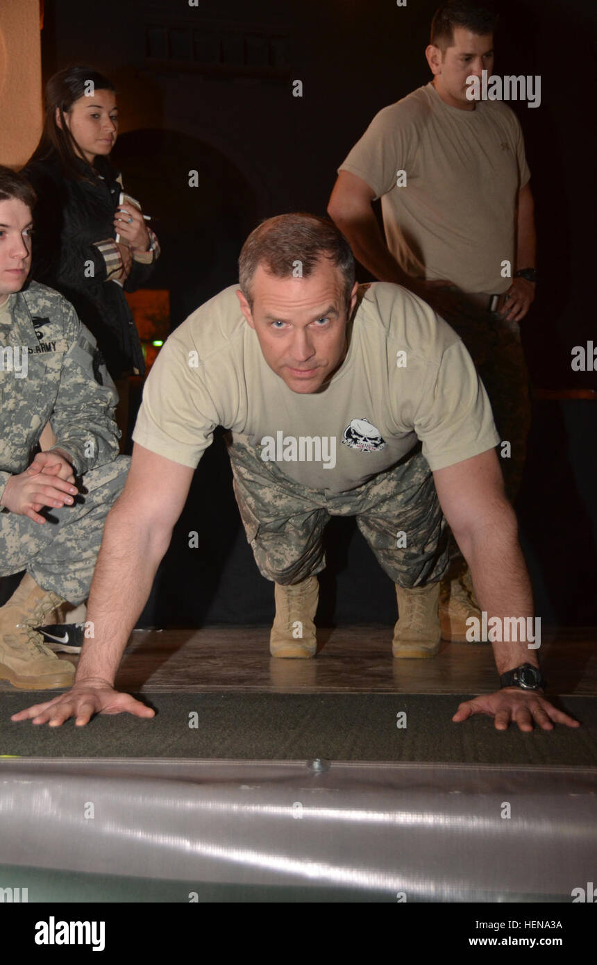 Sgt. 1st Class Matthew R. Lewis, a communications sergeant with the 10th Special Forces Group (Airborne) at Fort Carson, Colo., demonstrates the proper way to perform a pushup at the East-West challenge contest during All American Bowl week in San Antonio, Jan. 1, 2014. Lewis and nine other soldiers from the U.S. Army Special Operations Command are attending the event as mentors to 90 of the nation's top high school football stars, along with 125 top high school marching band musicians and Color Guard members. Culminating the weeklong activities is the U.S. Army All American Bowl, the premier  Stock Photo