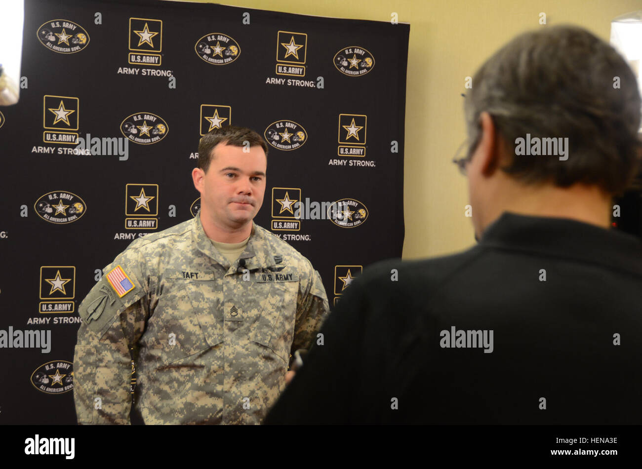 Staff Sgt. Matthew E. Taft takes part in an media interview with a local news outlet during All American Bowl week in San Antonio, Jan. 1, 2014. Taft, a combat veteran, is an MH-60 helicopter flight instructor at Fort Campbell, Ky. Taft and nine other soldiers from the U.S. Army Special Operations Command are in San Antonio as soldier mentors to 90 of the nation's top high school football stars, along with 125 top high school marching band musicians and Color Guard members. The weeklong event culminates with the Army's All American Bowl football game, the premier high school football game in t Stock Photo
