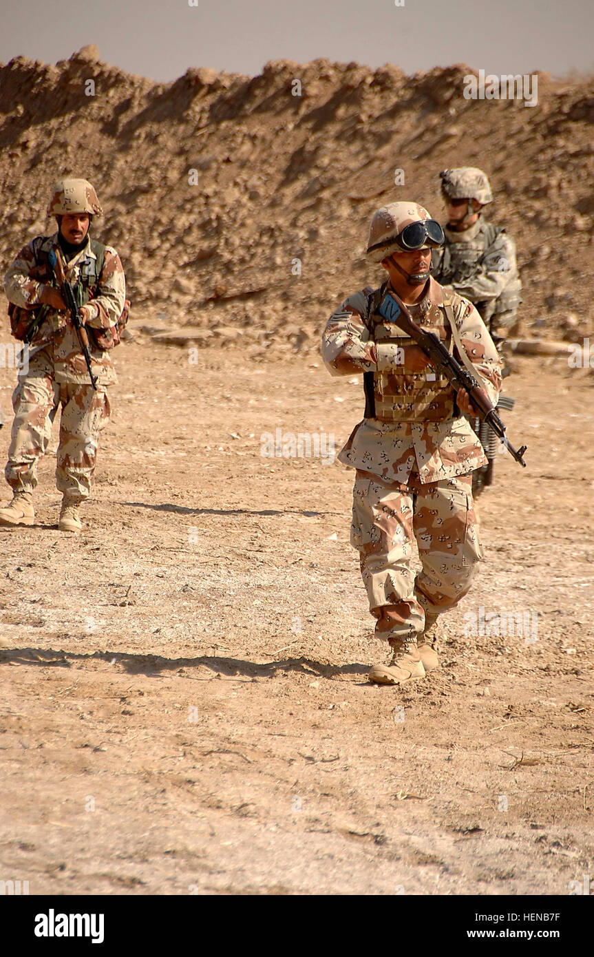 Iraqi Army (IA) Soldiers from the 2nd Light Infantry Battalion, 3rd Brigade, 8th Army Division, conduct a dismounted tactical movement exercise while training at Battle Position Eagle in Tanmiya, Iraq, Feb. 14, 2008. The IA Soldiers are training with U.S. Army Soldiers from the 0832 Military Transition Team (MiTT), 3rd Heavy Brigade Combat Team, 3rd Infantry Division. (U.S. Army photo by Sgt. Timothy Kingston) (Released) MiTT Training with Iraqi Army 80583 Stock Photo