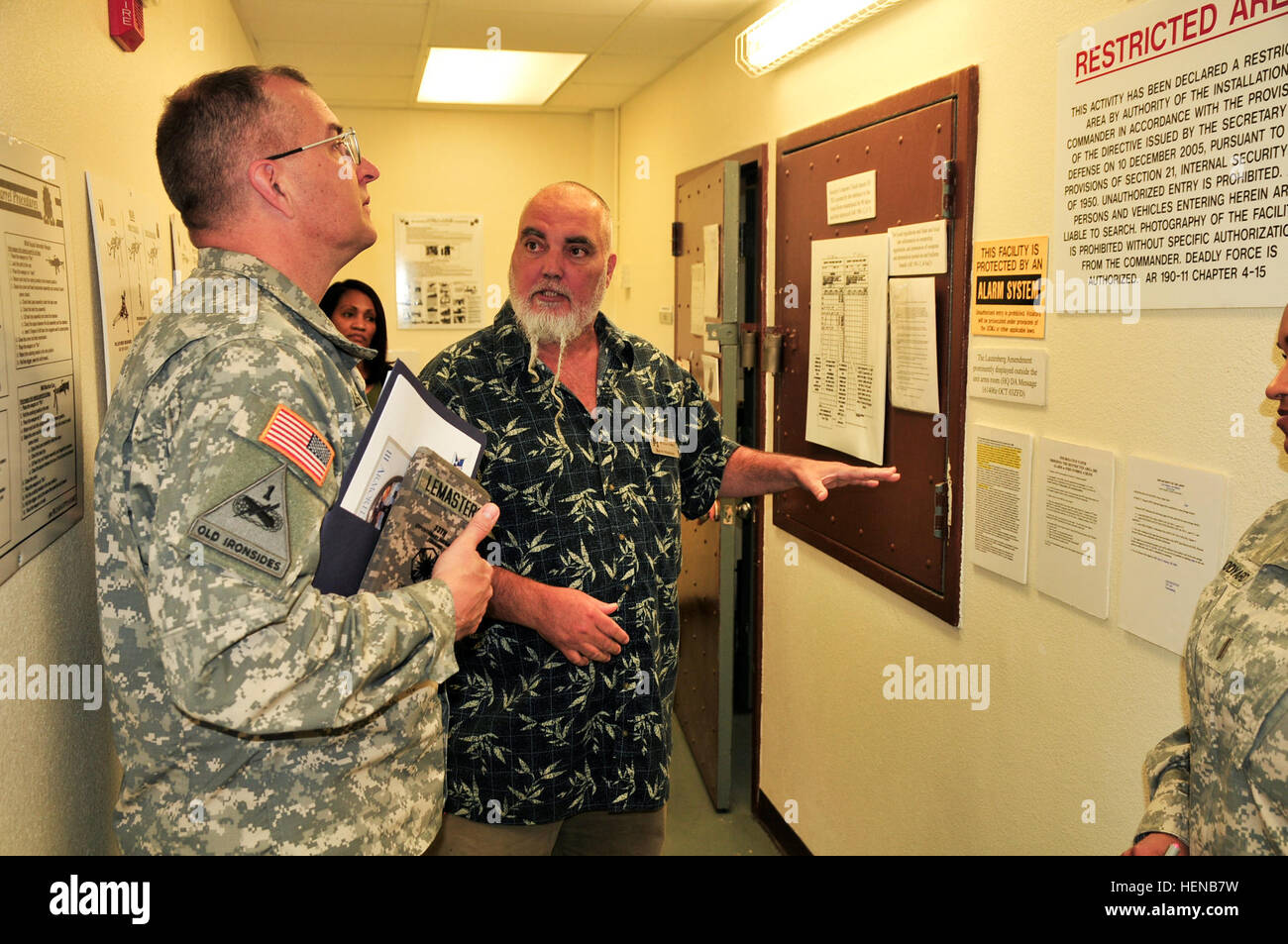 Kevin Madison (right), the small arms chief with the III Corps Command Maintenance Evaluation and Training (COMET) Team, discusses arms room standards and regulations with Brig. Gen. Clark W. LeMasters, the commanding general of 13th Sustainment Command (Expeditionary) and the senior logistician for Fort Hood, during a tour of the COMET Team training facilities Feb. 4. At the COMET facilities, they have a complete structured mock-up of a company level arms room, Chemical, Biological, Radiological and Nuclear (CBRN) cage, supply office, maintenance section, and a Supply Support Activity (SSA) b Stock Photo