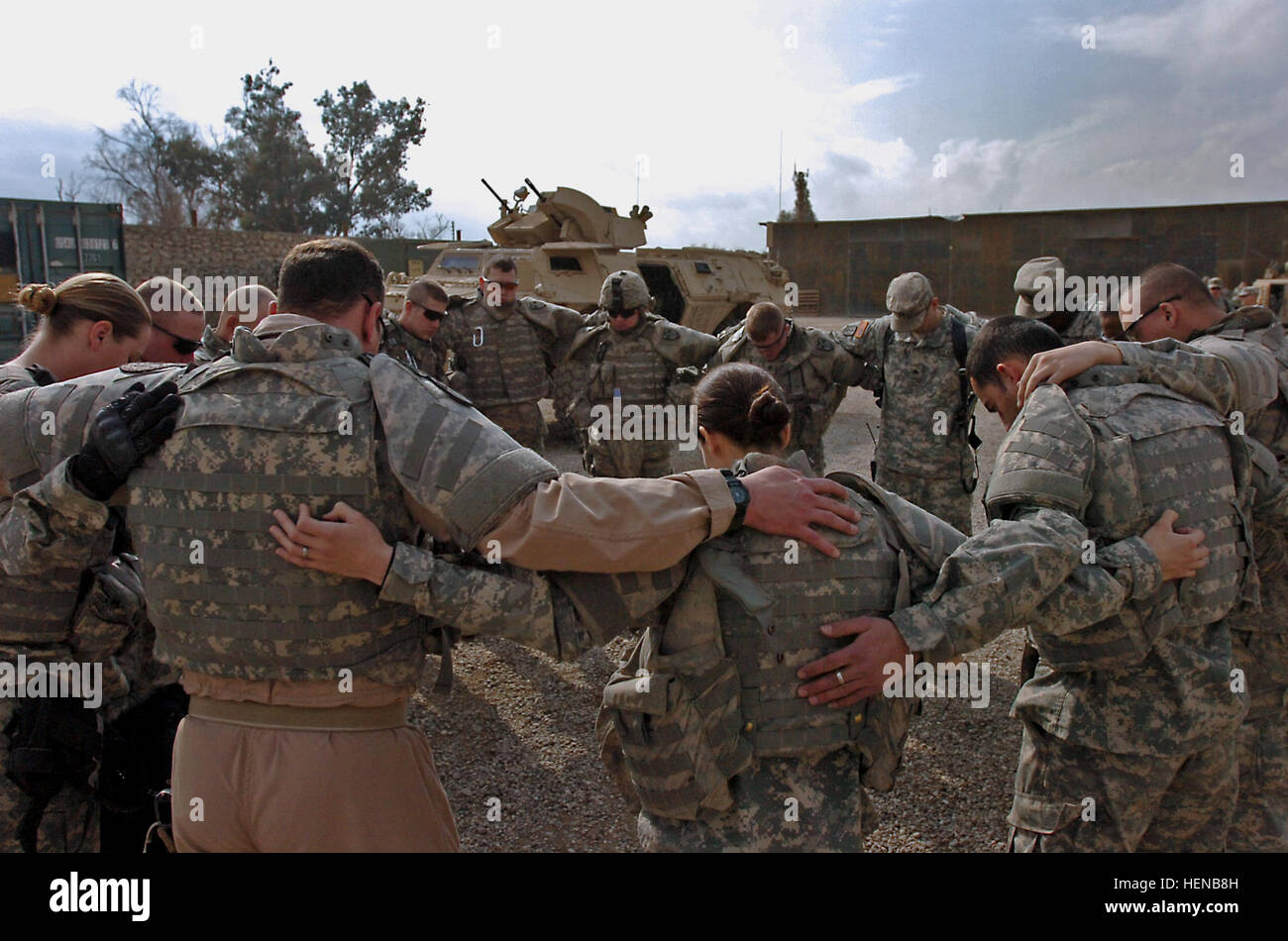 Soldiers from the 552nd Military Police Company, based out of Schofield Barracks, Hawaii, say a group prayer at a U.S. military base in Mosul before entering the city to search passenger vehicles for weapons and bomb-making materials on Feb. 14. 552nd MP's search for explosives in Mosul 77388 Stock Photo