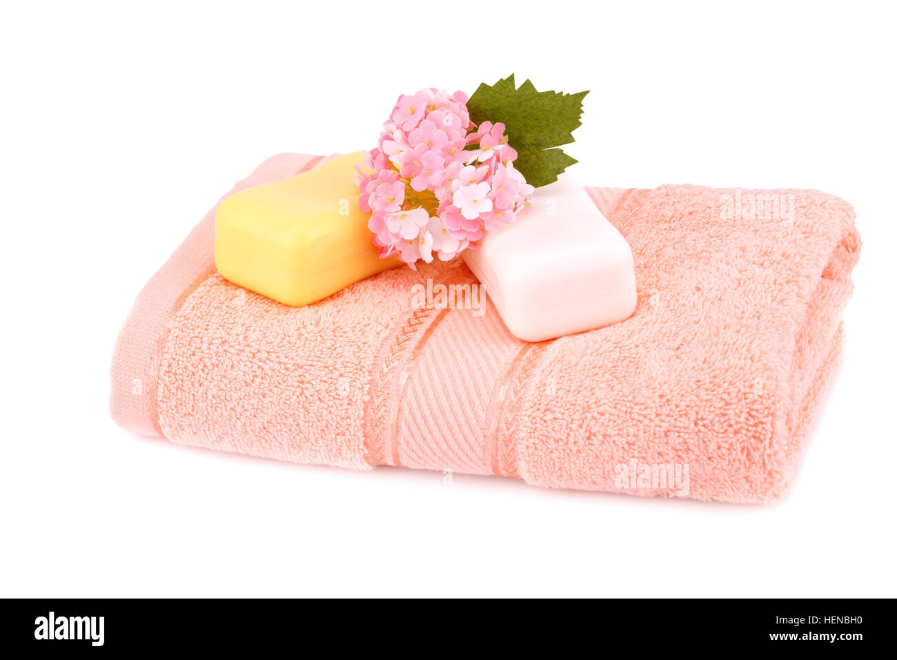 Folded towel and soaps isolated on white background. Stock Photo