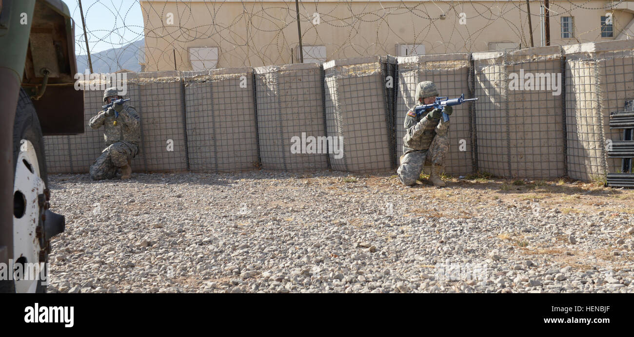 From left, Sgt. Jose Ramirez and Spc. Patrick Ferraris, both broadcast specialist with the 24th Press Camp Headquarters return fire during training on urban operations at Fort Bliss, Texas Feb. 10, 2014. Urban Operations 140212-A-EF558-045 Stock Photo