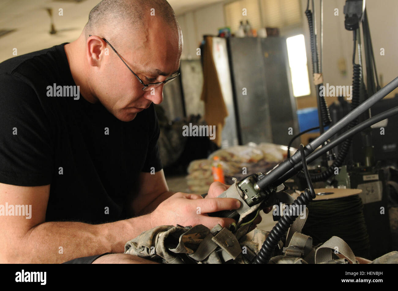 A U.S. Army soldier operates a PRC-152 Harris hand-held radio during ...