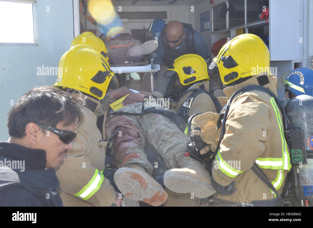 Firefighters And Paramedics Load A Notionally Injured Patient Into An ...