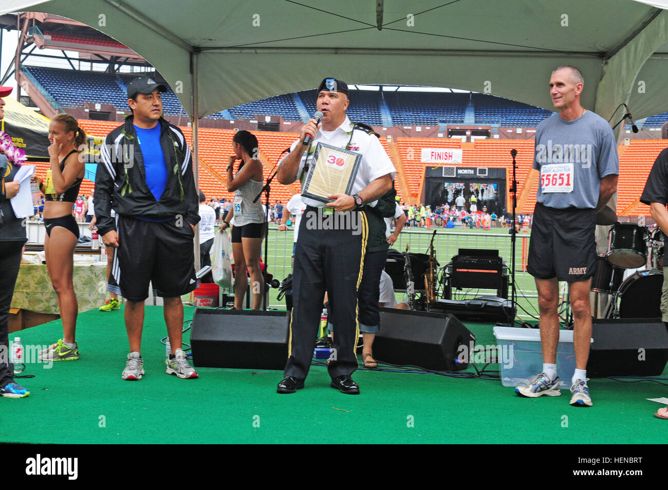 Maj. Gen. Anthony G. Crutchfield, chief of staff, U.S. Pacific Command, thanks the runners and the volunteers of the 30th annual Great Aloha Run during a presentation at the Aloha Stadium, Honolulu, Hawaii Feb. 17, 2014. Crutchfield accepted the plaque on behalf of PACOM for its participation in the event every year for the past 30 years. Great Aloha Run 2014 140217-A-BZ669-656 Stock Photo