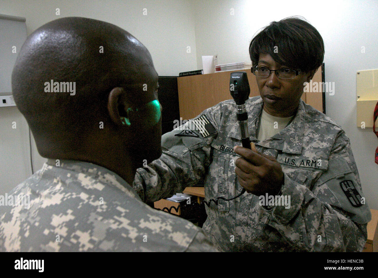 Col. Lorrie Oldham, deputy commander for Clinical Services at Camp Arifjan, Kuwait, with the 452nd Combat Support Hospital (Forward), examines a patient Feb. 24, 2014. Oldham has served in the Army for 30 years and counts her promotion to colonel as one of her life's greatest achievements. (U.S. Army photo by Sgt. Jennifer Spradlin, U.S. Army Central public affairs) In the spotlight, Army colonel leads by example 140224-A-OP586-639 Stock Photo