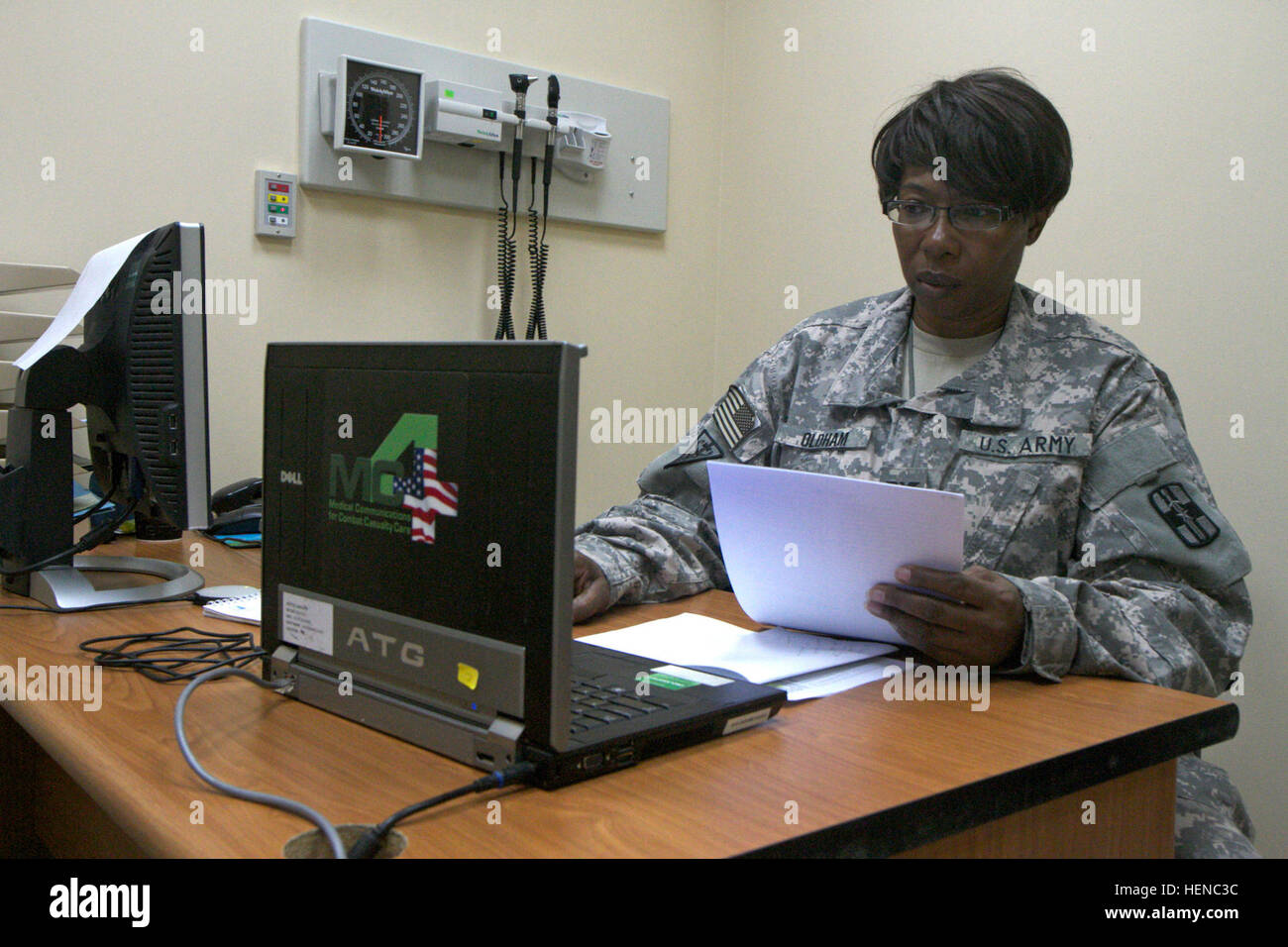 Col. Lorrie Oldham, deputy commander for Clinical Services at Camp Arifjan, Kuwait, with the 452nd Combat Support Hospital (Forward), reviews notes Feb. 24, 2014. Oldham is one of two black female colonels currently deployed to Camp Arifjan. (U.S. Army photo by Sgt. Jennifer Spradlin, U.S. Army Central public affairs) In the spotlight, Army colonel leads by example 140224-A-OP586-564 Stock Photo