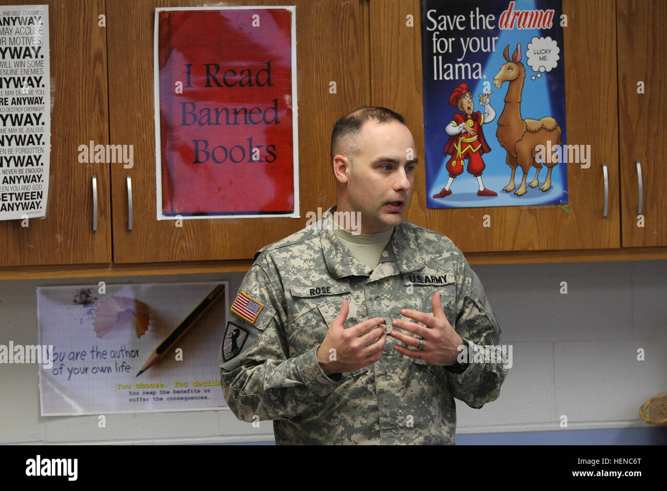 Staff Sgt. Jonathan Rose, the operations NCO of the military working dog section, 510th Military Police Detachment (Military Working Dog), 716th Military Police Battalion, 101st Sustainment Brigade, 101st Airborne Division (Air Assault), talks to students Feb. 26, at Wassom Middle School at Fort Campbell. Rose taught the students about how MPs use dogs to keep the installation safe. (U.S. Army photo by Sgt. Leejay Lockhart, 101st Sustainment Brigade Public Affairs) Military Working Dog team visits students 140226-A-LS265-022 Stock Photo