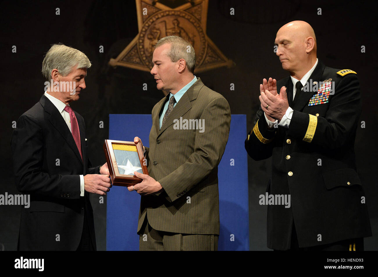 Secretary of Army John McHugh, left, presents the Medal of Honor Flag to Tyronne Espinoza, on behalf of his father Cpl. Victor H. Espinoza, one of 24 Army veterans honored during the Valor 24 Hall of Heroes Induction ceremony, held at the Pentagon, Washington D.C., March 19, 2014. Participating in the presentations is Chief of Staff of the Army, Gen. Raymond Odierno. (U.S. Army photo by Mr. Leroy Council/Released) Valor 24 Hall of Heroes Ceremony, presentation for Victor H. Espinoza Stock Photo