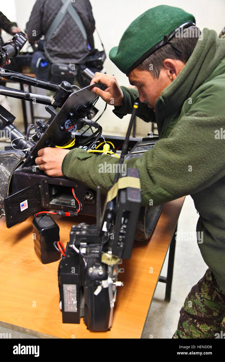 An Afghan National Army soldier of the 203rd Corps repairs a remote