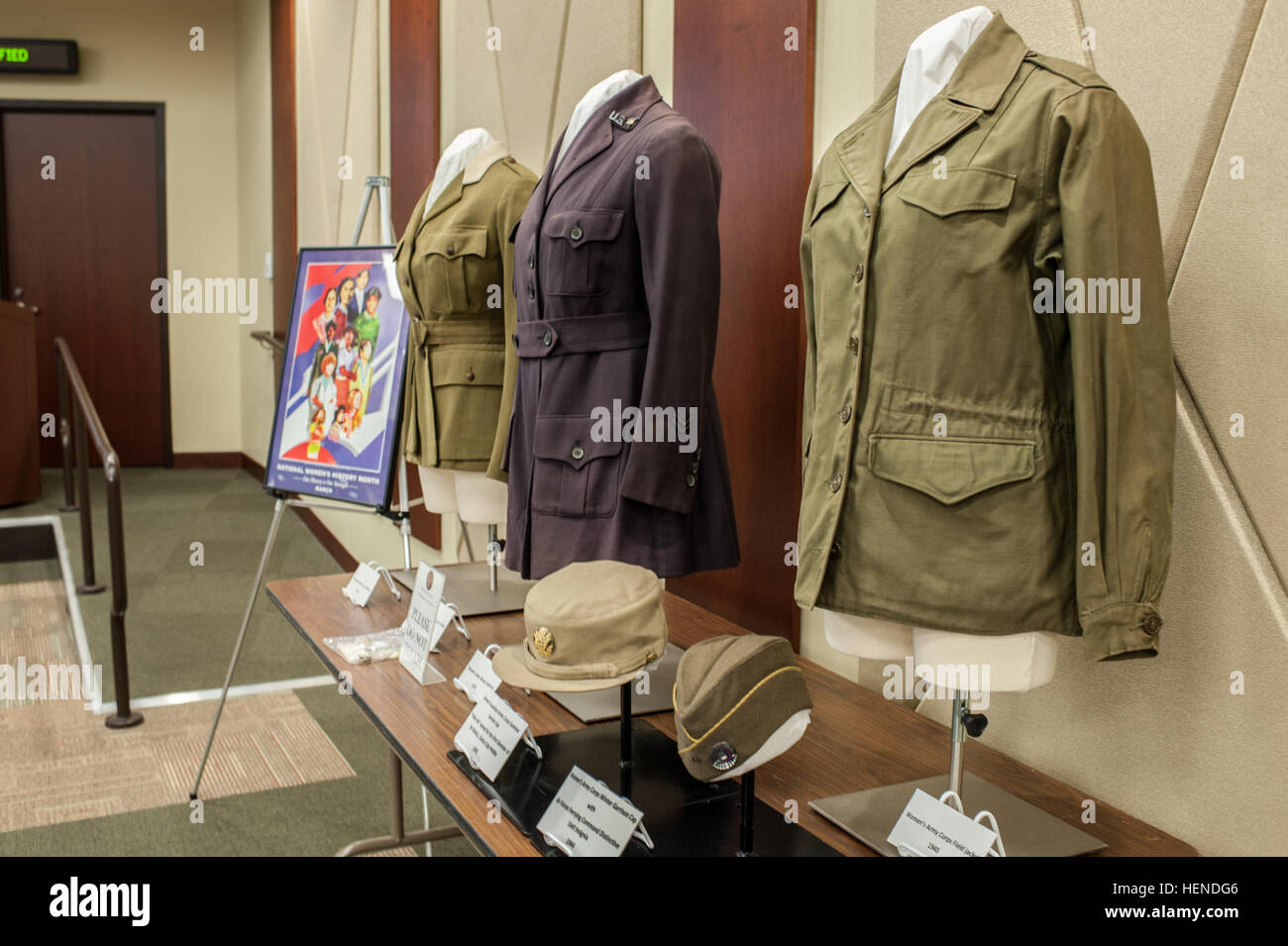 Women's Army uniforms and hats on display during a Women's History month presentation by Maj. Gen. Marcia M. Anderson, the Deputy Chief, U.S. Army Reserve, at the U.S. Army Reserve Command headquarters at Fort Bragg, N.C., March 25, 2014. Anderson, the Army's first African American female major general highlighted the accomplishments of women dating back to the Revolutionary War and the current evaluation process of opening previously closed military occupations to women. (U.S. Army photo by Timothy L. Hale/Released) Women continue to prove themselves in uniform 140325-A-XN107-845 Stock Photo