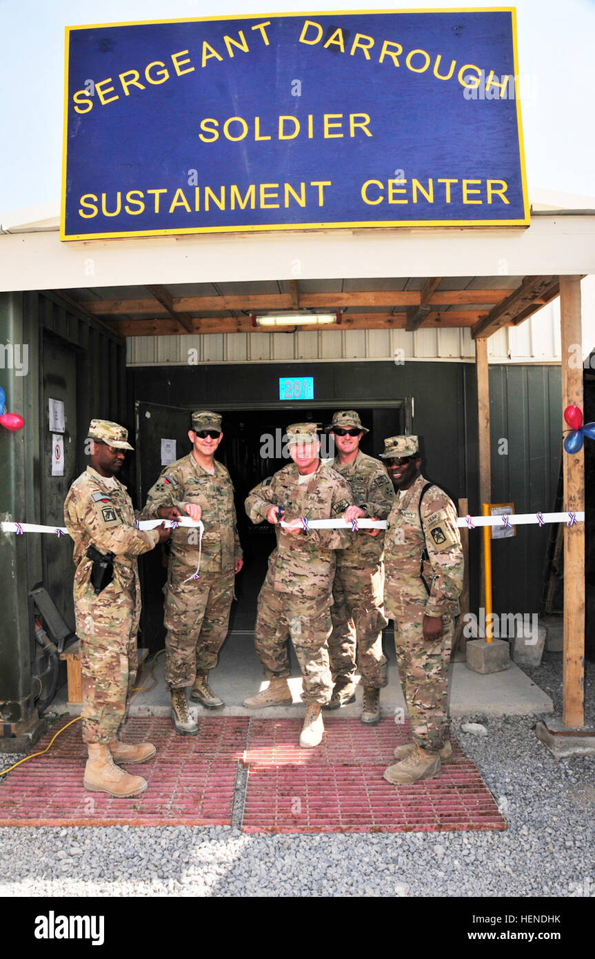 Air Force Brig. Gen. Michael Fantini, commander of Kandahar Airfield cuts the ceremonial ribbon at the grand opening of the Sgt. Darrough Soldier Sustainment Center on KAF, Afghanistan, March 26. Looking on, from left, are Army Col. Fletcher Washington, KAF garrison commander; Army Col. Jeffery Sims, former KAF garrison commander; Army Lt. Col. Roger Swartwood, KAF garrison director of public works; and Army Lt. Col Gregory Sanders, 10th Special Troops Battalion commander. The facility was constructed to consolidate the finance, main post office, identification card section, and the Regional M Stock Photo