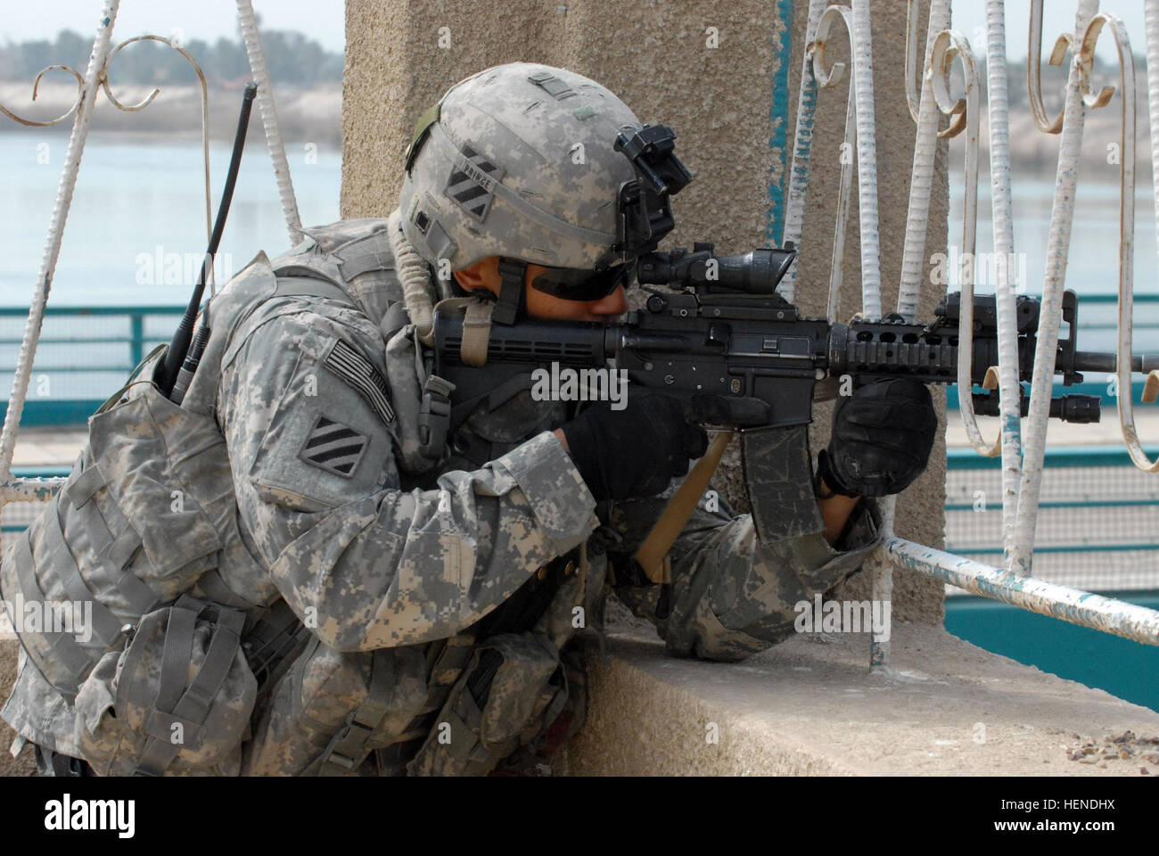 Sgt. William Prince, a Miami native who serves as a member of the personal security detachment for 3rd Squadron, 7th Cavalry Regiment, 2nd Brigade Combat Team, 3rd Infantry Division, looks through his scope as he provides security near the Tigris River. Prince, and other members of the 3rd Sqdn., 7th Cav. Regt., which is currently attached to the 3rd Brigade Combat Team, 4th Infantry Division, Multi-National Division - Baghdad, provided security while religious leaders of the Sunni dominated Adhamiya and Shia populated Khadamiya neighborhoods met in a nearby mosque. Sunni, Shia leaders meet; r Stock Photo