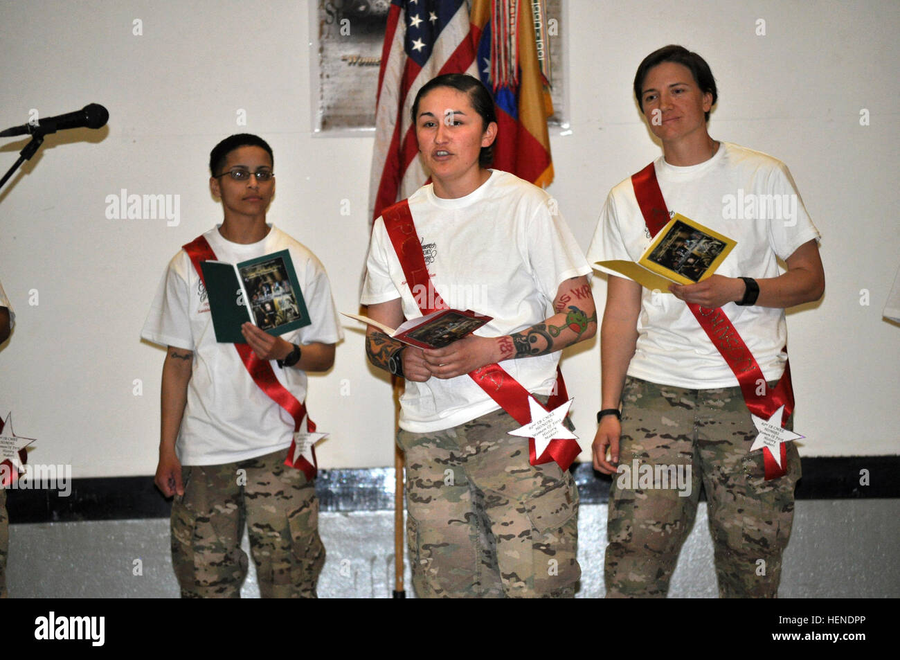 Azusa, Calif. native, Sgt. Angalique Reedy (center), a combat medic with the Fort Bragg, N.C.-based 82nd Sustainment Brigade-U.S. Central Command Materiel Recovery Element, portrays Spc. Lori Ann Piestewa during a dramatic reading as part of the 82nd SB-CMRE Women's History Observance Month presentation March 29 at Kandahar Airfield, Afghanistan. Piestewa was the first woman service member killed in combat during Operation Iraqi Freedom and the first-ever Native American woman killed in combat as a U.S. military service member. (U.S. Army photo by Master Sgt. Tonisha Woods, 82nd SB-CMRE) 82nd  Stock Photo