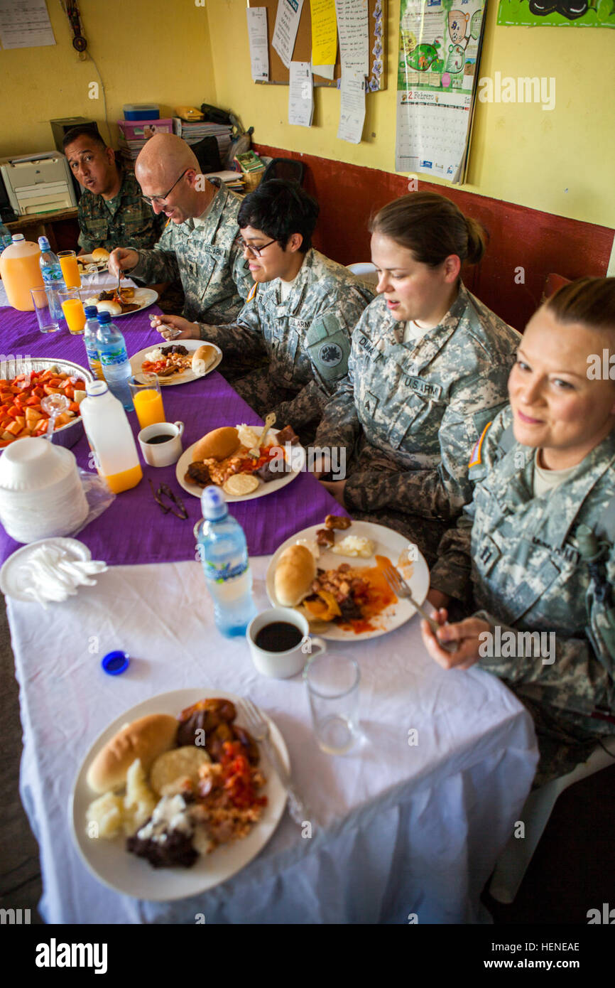 U.S. Soldiers from Task Force Oso eat an authentic meal after watching Guatemalan students perform the Stations of the Cross during Beyond the Horizon 2014, Zacapa, Guatemala, Apr. 11, 2014. Beyond the Horizon is an annual exercise that embraces the partnership between the United States and Guatemala, to provide focused humanitarian assistance through various medical, dental, and civic action programs. (U.S. Army photo by Staff Sgt. Justin P. Morelli / Released) Beyond The Horizon 2014, Guatemala 140411-A-PP104-093 Stock Photo