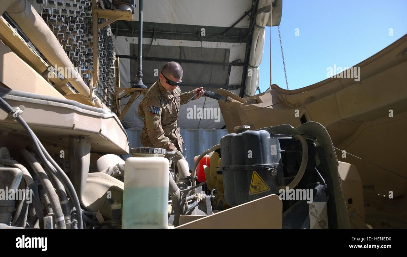 Spc. William Fuller, an automotive mechanic assigned to the 514th Support Maintenance Company, verifies proper fluid levels in the engine of a Maxxpro, Mine Resistant Ambush Protected Vehicle. The mechanics who are part of the Pit Stop crew conduct a quality assurance check for all vehicles in a convoy before leaving on missions. Fluid check 140503-A-AC123-005 Stock Photo