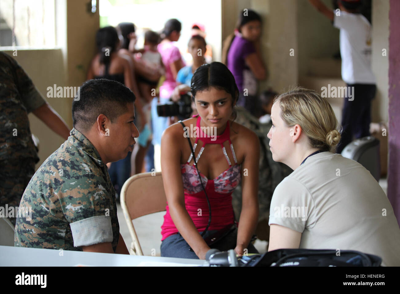 U.S Air Force Capt. Diana Meda of the 60th MDOS, speaks with a Guatemalan Solider as he translated for a Local women attending a Medical Readiness Exercise during Beyond the Horizon, Gualan, Guatemala, April 22, 2014.  Beyond the Horizon is an annual exercise that embraces the partnership between the United States and Guatemala, to provide focused humanitarian assistance through various medical, dental, and civic action programs. (U.S. Army photo by Sgt. Cameron Boyd/released) Beyond The Horizon 2014, Guatemala 140421-A-TH742-007 Stock Photo