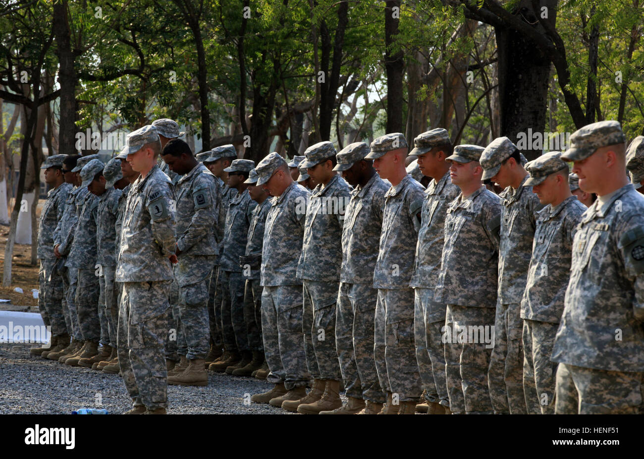 U.S Military personnel assigned to Task Force Oso, bow their head in remembrance to their fallen comrade Spc. Hernaldo Beltran, who passed away during Beyond the Horizon in Zacapa Guatemala, April 25, 2014. Beyond the Horizon is an annual exercise that embraces the partnership between the United States and Guatemala, to provide focused humanitarian assistance through various medical, dental and civic action programs. (U.S. Army photo by Sgt. Cameron Boyd/released) Beyond The Horizon 2014, Guatemala 140425-A-TH742-294 Stock Photo
