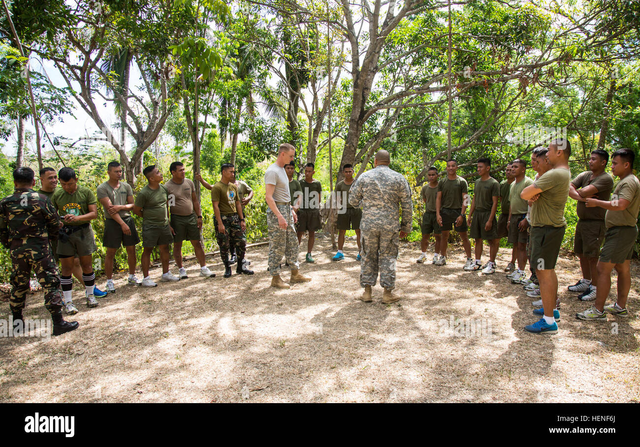 Philippines Military Police Company, 7th Infantry Division, and U.S. Army Soldiers discuss proper detainee operations during detainee handling training on Fort Magsayay, Philippines, April 26, 2014. The training is part of Balikatan 2014 and is to enhance the tactics, techniques and procedures of both Philippines and U.S. Soldiers. This year marks the 30th iteration of the exercise, which is an annual Republic of the Philippines-U.S. military bilateral training exercise and humanitarian civic assistance engagement.  (U.S. Army Photo by Spc. Michael G. Herrero/Released) AFP-US MP training 14042 Stock Photo