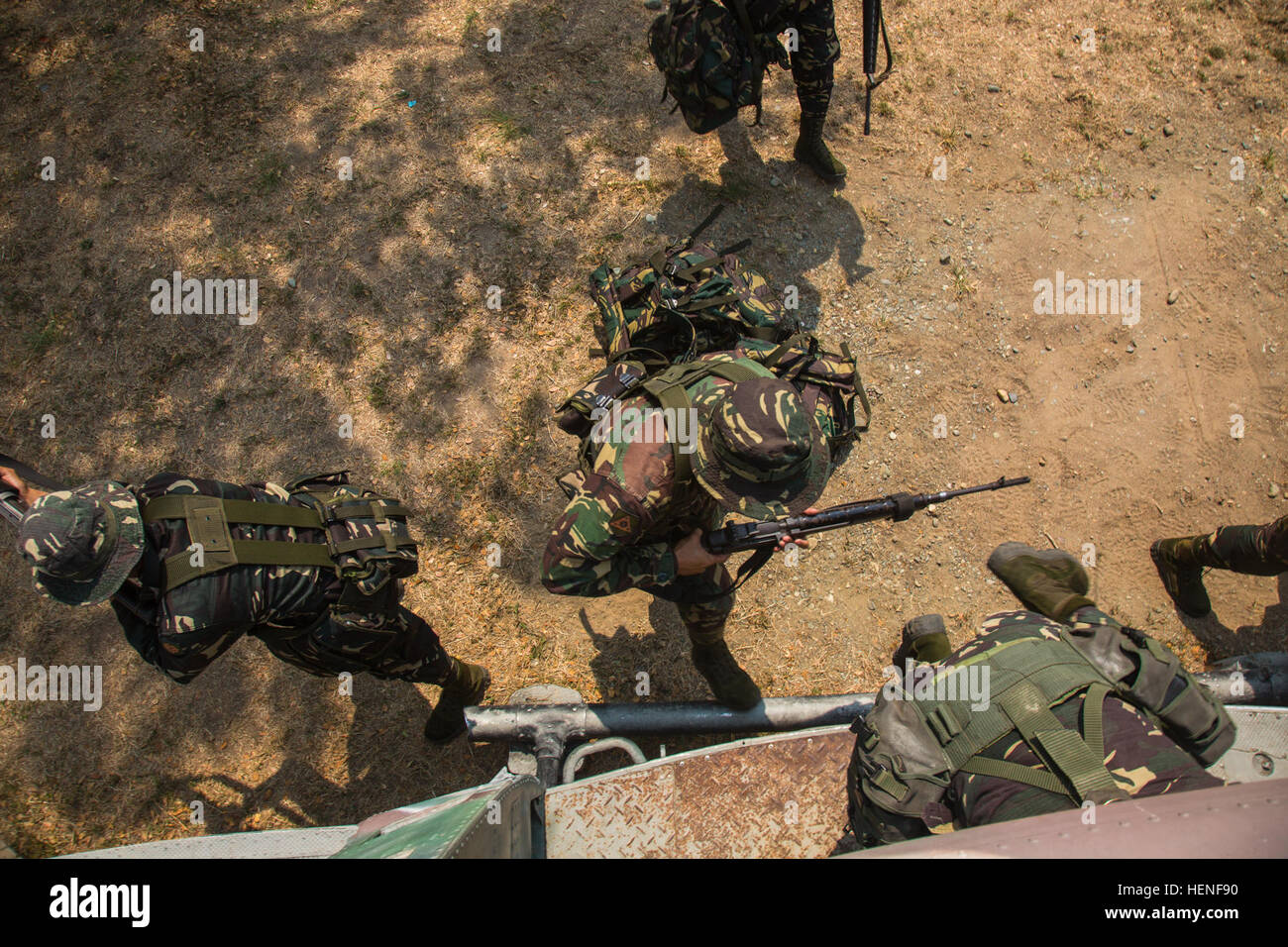 Philippine Army Soldiers with 20th Infantry Battalion, 8th Infantry Division, load a simulated helicopter for static load training during exercise Balikatan 2014 on Fort Magsaysay, Philippines, April 28, 2014.  The purpose of the training is to learn air assault tactical loading and unloading using a simulated helicopter.  This year marks the 30th iteration of the exercise, which is an annual Republic of the Philippines-U.S. military bilateral training exercise and humanitarian civic assistance engagement.  (U.S. Army Photo by Spc. Michael G. Herrero/Released) Philippine and US Army conduct st Stock Photo