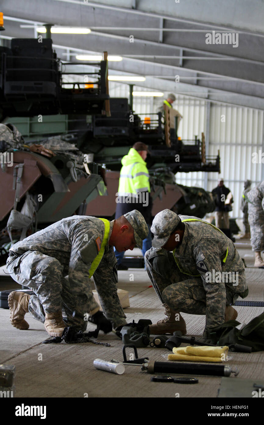 First Lt. Carl Moulton and Spc. LaQuan Dorsey, tankers from 2nd Battlion, 5th Cavalry Regiment receives, inventories and assembles new tools and parts that he received with his European Activity Set M1A2 Abrams main battle tank. The 2-5 Cav. will use the European Activity Set for exercise Combined Resolve II, and their duration as the European Rotational Force. (U.S. Army photos by 1st Lt. Henry Chan, 16th Sustainment Brigade, 21st Theater Sustainment Command) Knight%%%%%%%%E2%%%%%%%%80%%%%%%%%99s Brigade in the box %%%%%%%%E2%%%%%%%%80%%%%%%%%93 Part II, EAS draw 140503-A-WZ553-524 Stock Photo