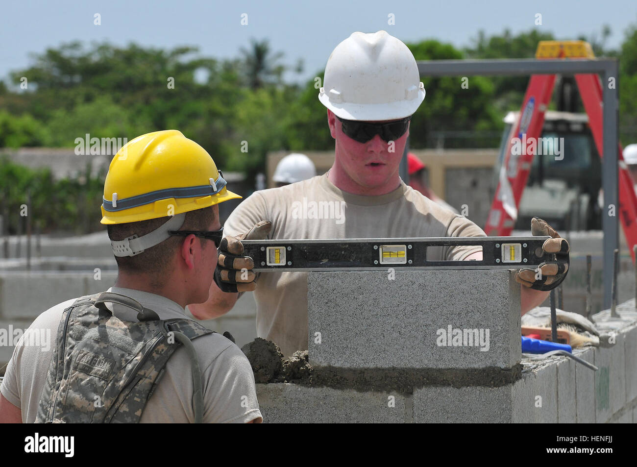 Spc. Justin Smith, a native of Sumner, Iowa, levels the concrete blocks