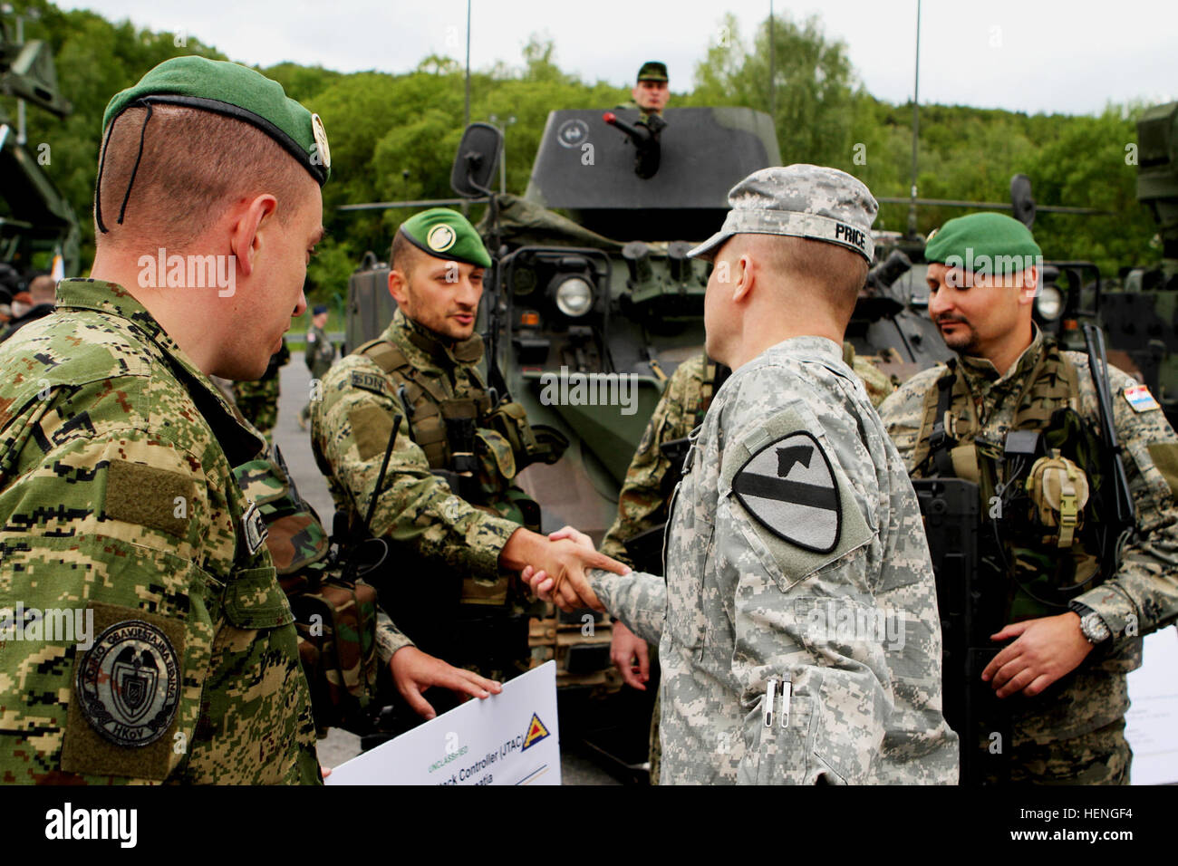 Lt. Col Carter Price, commander of 2nd Battalion, 5th Cavalry Regiment, 1st Brigade Combat Team, 1st Cavalry Division, shakes hands with Croatian Soldiers during a capabilities day presentation prior to the start of Combined Resolve II. Secretary of the Army John M. McHugh focused on the implementation of U.S. Army Europe's regionally aligned forces concept while observing Soldiers and NATO and European partners at exercise Combined Resolve II. Partnership for Combined Resolve II 140517-A-SJ786-028 Stock Photo