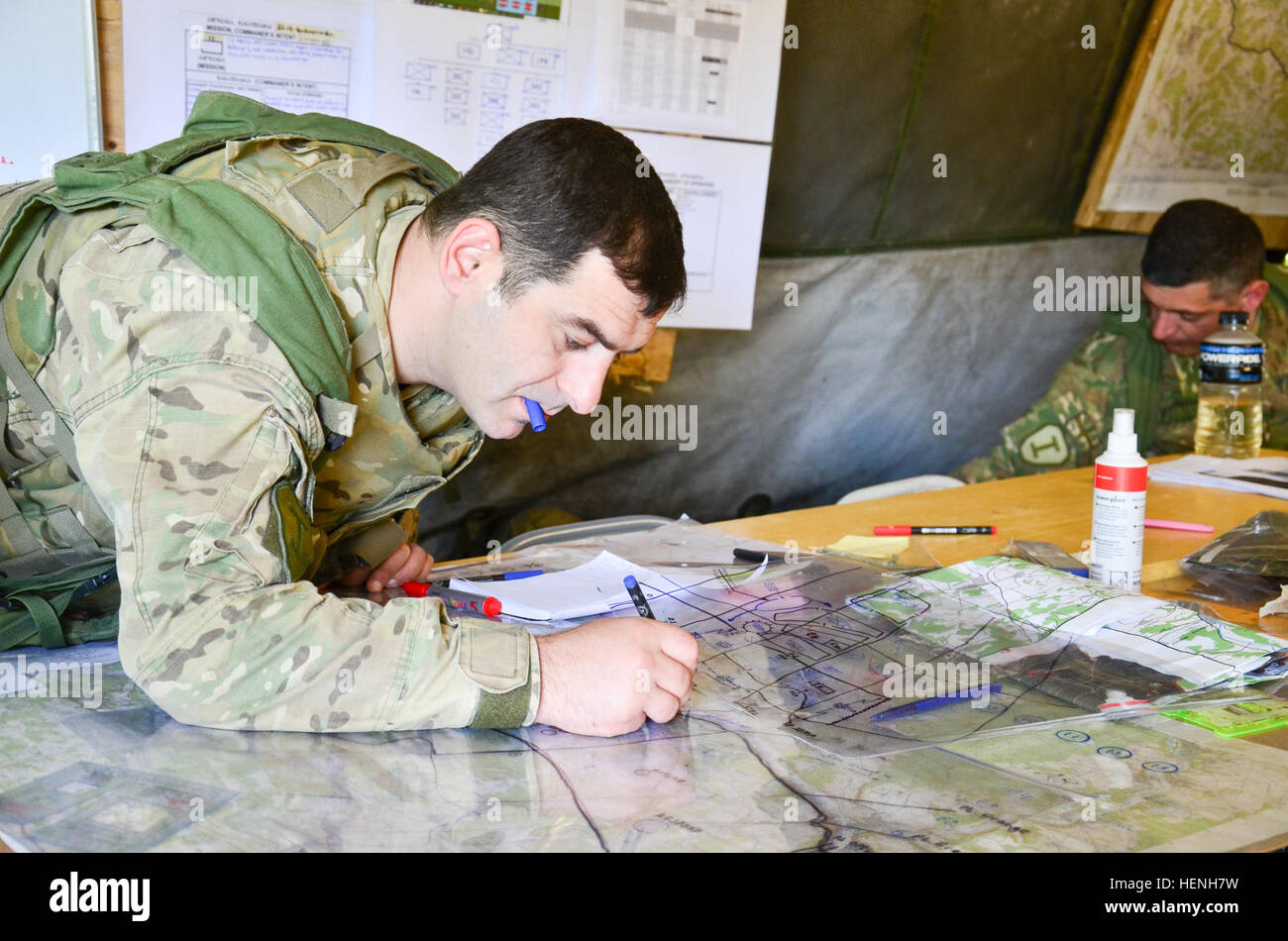 A Georgian soldier updates map coordinates during exercise Combined Resolve II at the Joint Multinational Readiness Center in Hohenfels, Germany, May 25, 2014.  Combined Resolve II is a multinational decisive action training environment exercise occurring at the Joint Multinational Training Command’s Hohenfels and Grafenwoehr Training Areas that involves more than 4,000 participants from 15 partner nations.  The intent of the exercise is to train and prepare a U.S. led multinational brigade to interoperate with multiple partner nations and execute unified land operations against a complex thre Stock Photo