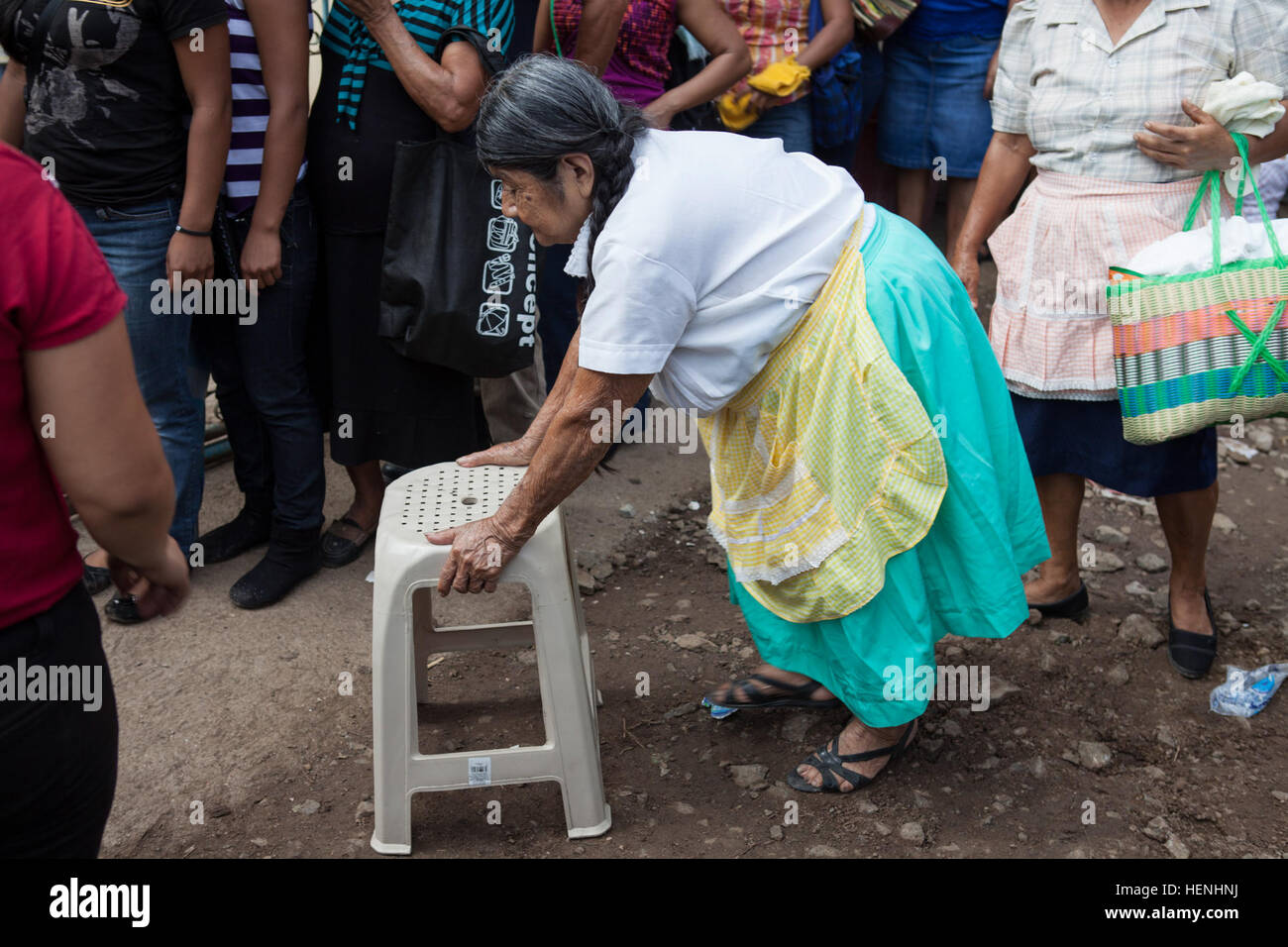 An elderly woman uses a stool as a walker while awaiting a Medical Readiness Training Exercise provided by Task Force Oso in support of Beyond the Horizon in Rio Grande, Guatemala, on June 3, 2014.  Beyond the Horizon is an annual exercise that embraces the partnership between the United States and Guatemala, to provide focused humanitarian assistance through various medical, dental, and civic action programs. (U.S. Army photo by Cpl. Michael Spandau/Released) Beyond The Horizon 2014, Guatemala 140603-A-TX665-002 Stock Photo