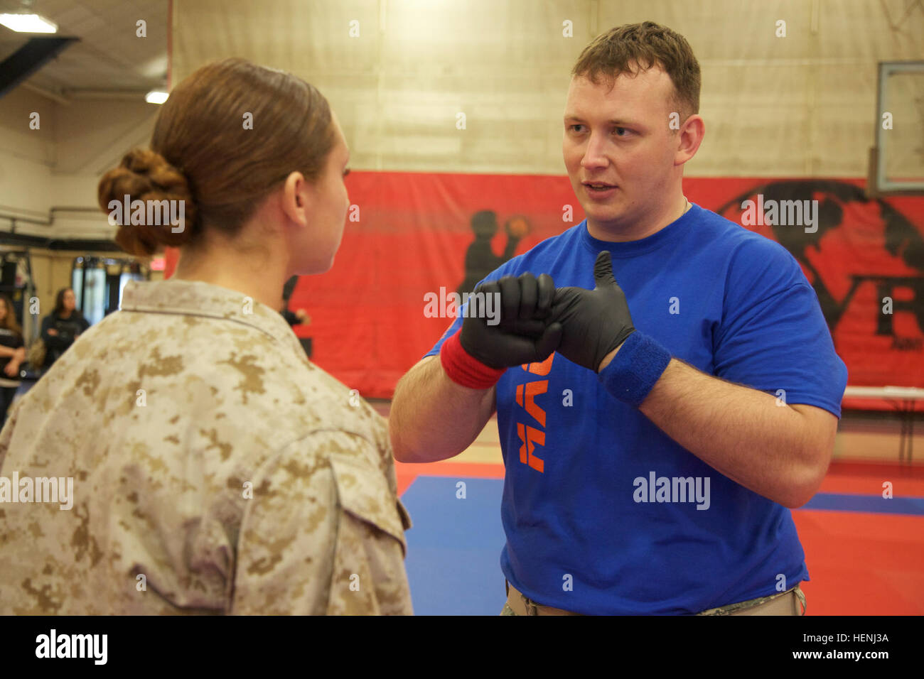 U.S. Army Staff Sgt. Justin Young, assigned to 3rd Brigade, 98th Division, explains the rules to a U.S. Marine competitor during an Army Combatives Tournament at Fort Dix, N.J., June 7, 2014. This tournament includes Soldiers, Airmen and Marines competing in different weight classes for a chance to win the title. (U.S. Army photo by Sgt. Austin Berner/Released) 98th Division Army Combatives Tournament 140607-A-BZ540-151 Stock Photo