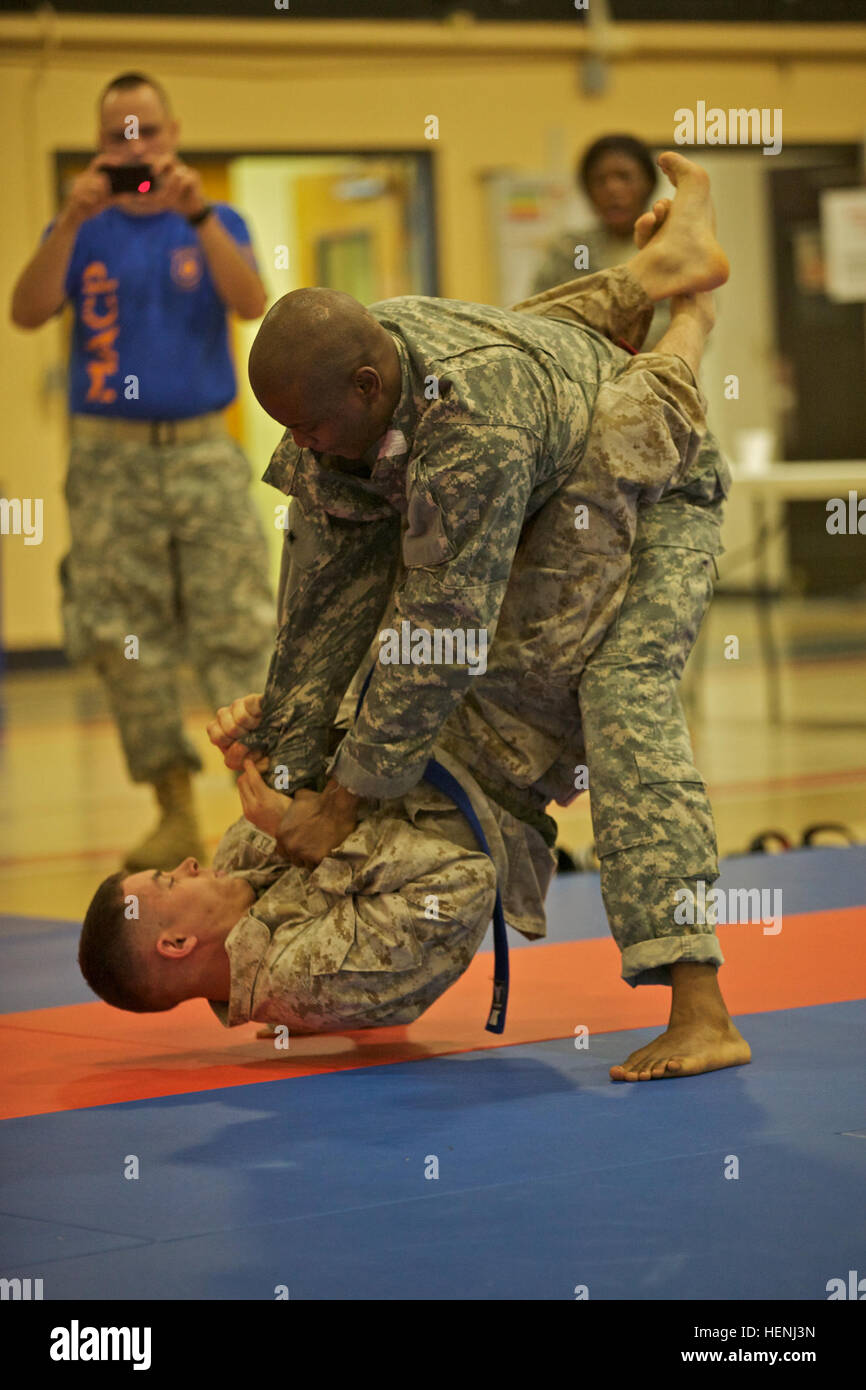 A U.S. Army Soldier and U.S. Marine fight head to head during an Army Combatives Tournament at Fort Dix, N.J., June 7, 2014. This tournament includes Soldiers, Airmen and Marines competing in different weight classes for a chance to win the title. (U.S. Army photo by Sgt. Austin Berner/Released) 98th Division Army Combatives Tournament 140607-A-BZ540-192 Stock Photo