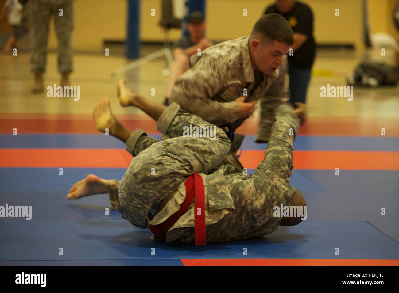 A U.S. Army Soldier and U.S. Marine fight head to head during an Army Combatives Tournament at Fort Dix, N.J., June 7, 2014. This tournament includes Soldiers, Airmen and Marines competing in different weight classes for a chance to win the title. (U.S. Army photo by Sgt. Austin Berner/Released) 98th Division Army Combatives Tournament 140607-A-BZ540-205 Stock Photo