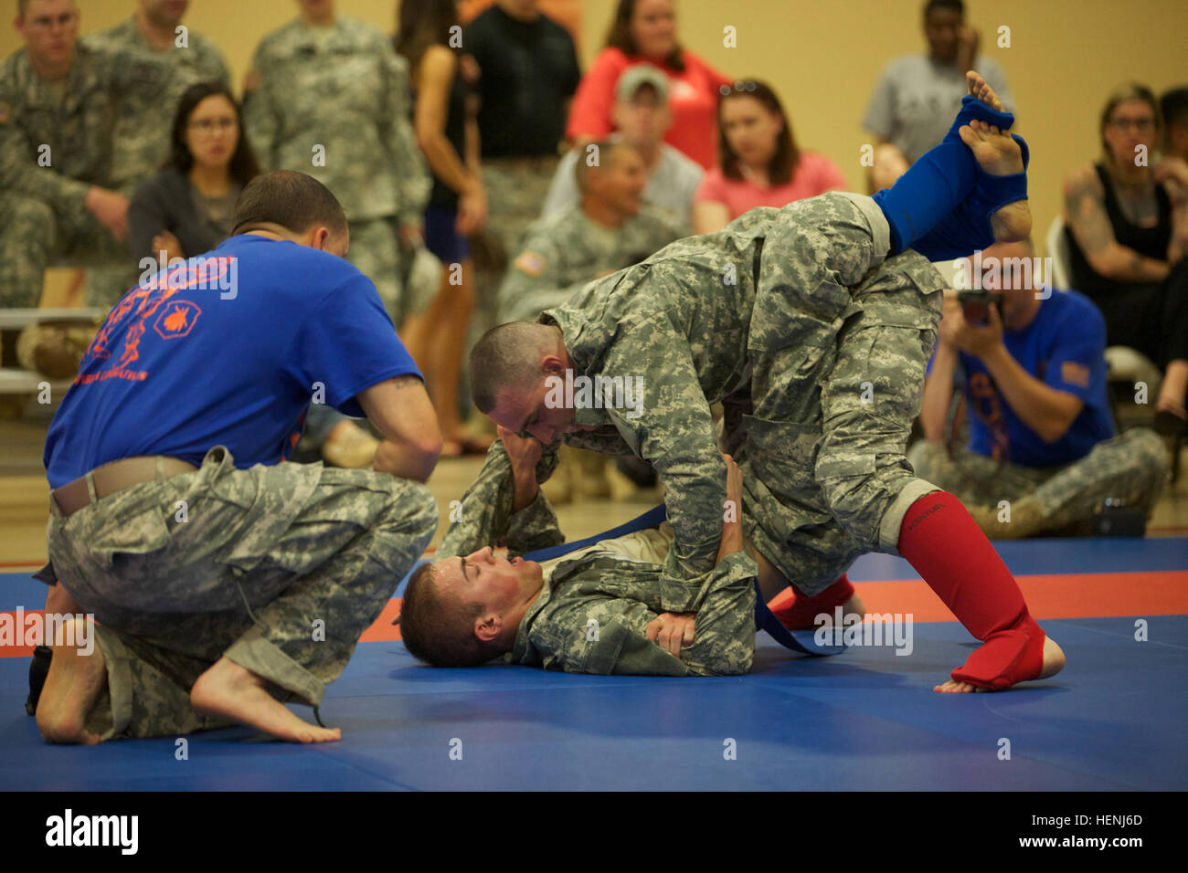 A U.S. Army Staff Sergeant referees two competitors in hand-to-hand ...