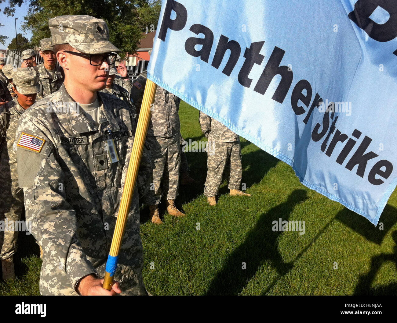 Spc. Tyler Kerstetter, a human intelligence collector with the 260th Military Intelligence (MI) Battalion, Florida National Guard, holds a guidon while posted in front of his newly formed training battalion during the initial organization of Panther Strike 2014's training task force on June 9. Several notional battalions composed of military intelligence (MI) soldiers, hailing from across the U.S. and possessing specialties in various MI disciplines, will synchronize their efforts during the exercise to simulate the intelligence operations of a deployed combined joint task force. Cal Guard MI  Stock Photo