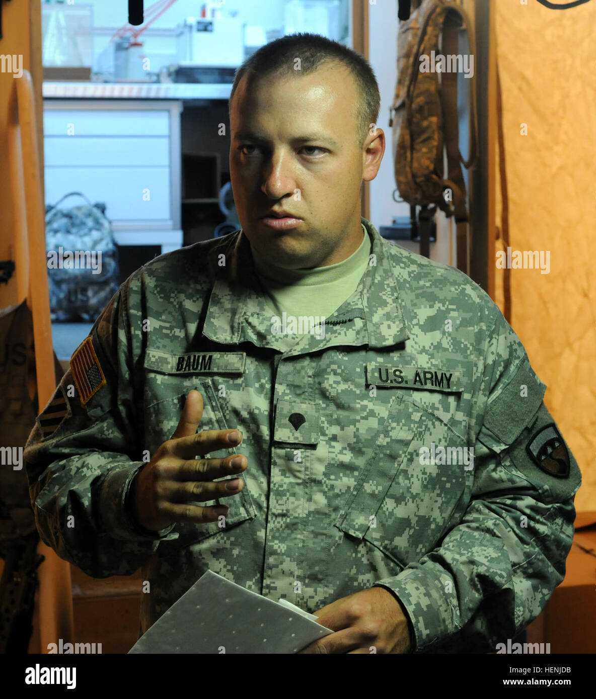 Spc. Zachary Baum, petroleum laboratory specialist, explains his