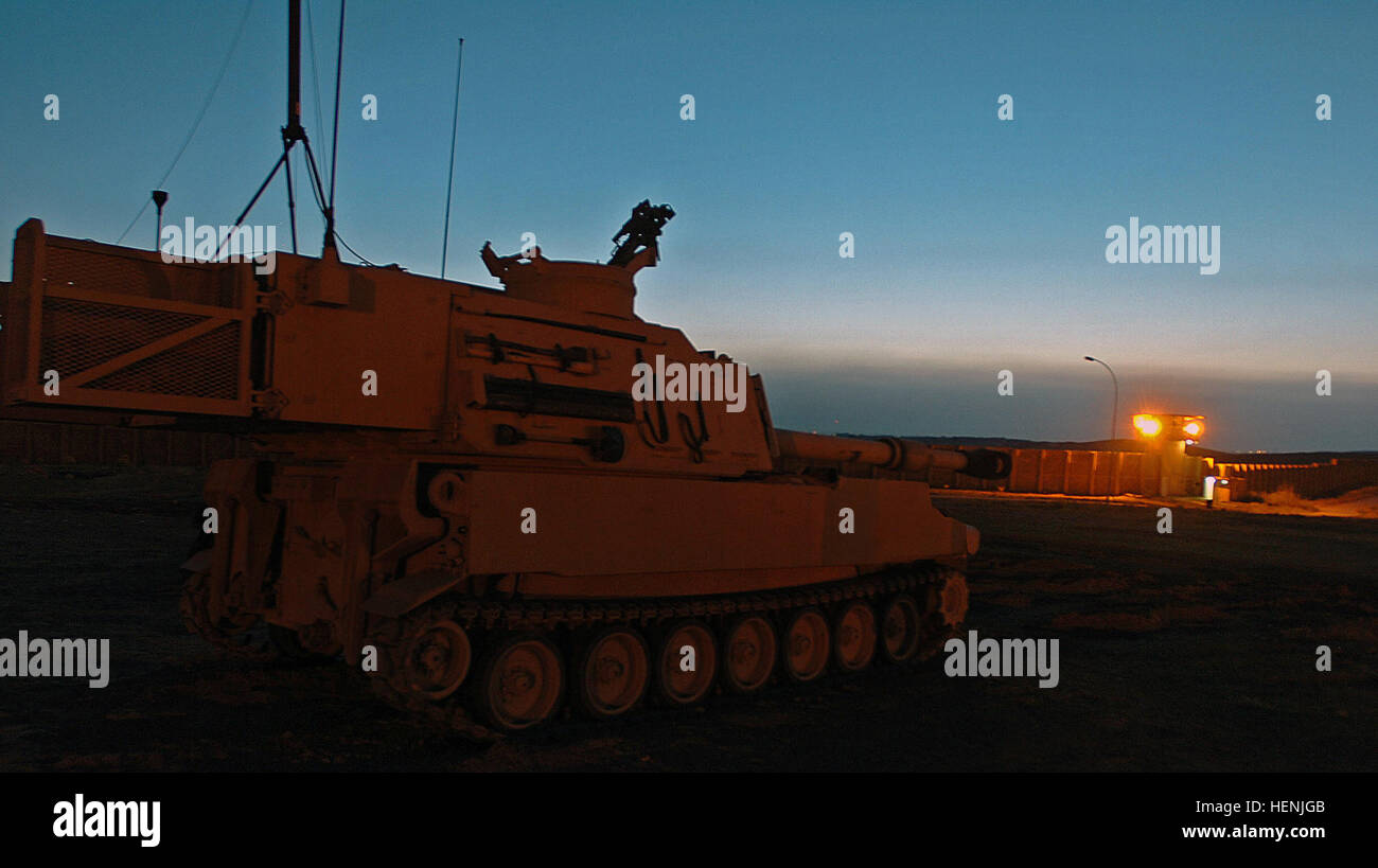 An M109A6 Paladin rests overwatching Badoush Prison, just outside of Mosul, March 28. The Howitzer belongs to Howitzer Battery, 3d Armored Cavalry Regiment from Fort Hood, Texas. The Battery fires an average of three fire missions a night. Paladin Howitzers fire rounds in support of ground troops 82414 Stock Photo