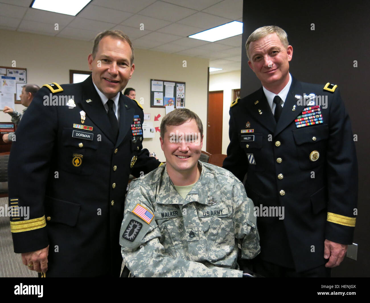 Staff Sgt. Chris Walker (middle), a former team leader with the 706th Explosive Ordnance Disposal Company, 303rd EOD Battalion out of Schofield Barracks, Hawaii, poses with Maj. Gen. Edward F. Dorman III (left), the Deputy G4 for the Office of the Deputy Chief of Staff, and Brig. Gen. John F. Haley (right), the chief of ordnance and Ordnance School commandant, after being presented his master rating, the Master EOD Badge, June 11, at Walter Reed National Military Medical Center in Bethesda, Md. EOD leader, triple amputee earns DOD master rating badge 140611-A-ZZ999-001 Stock Photo