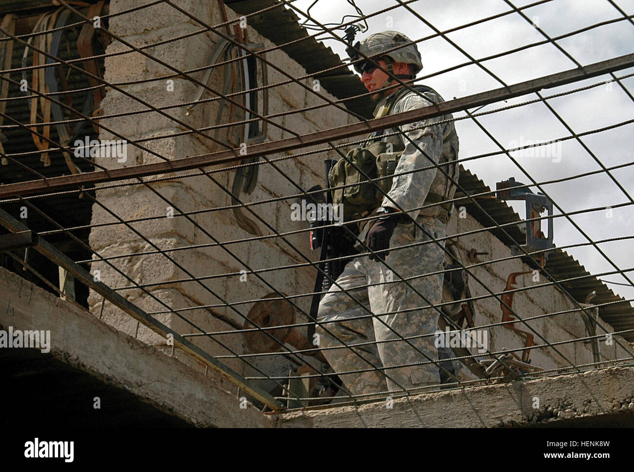 Sgt. James Crawford III, an infantryman in 1st Platoon, Company D, 1st Battalion, 8th Infantry Regiment from Fort Carson, Colo., searches the rooftop of a business in the al-Sinaa neighborhood of Mosul, Iraq, April 1, during an Iraqi Army led raid. Infantry Soldiers Conduct Mosul Raid Through Rain and Shine 83265 Stock Photo