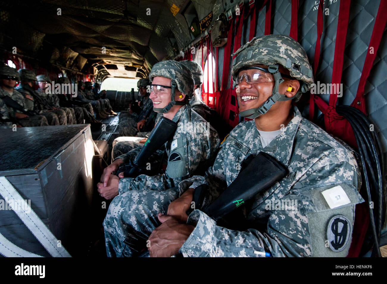 Spc. Stanley Hale, living in Blythe, California, belonging to the 108th Training Commmand, and Spc. Joshua Hawn, of Cherry Hill, New Jersey, with the 78th Training Division, share a laugh while riding on a CH-47 Chinook helicopter as part of the 2014 Army Reserve Best Warrior Competition at Joint Base McGuire-Dix-Lakehurst, New Jersey, June 24. During the flight, the chinook dipped and angled into sharp turns to get the competitors used to the a typical combat flight experience. (U.S. Army photo by Sgt. 1st Class Michel Sauret) 2014 Army Reserve Best Warrior Competition 140624-A-TI382-690 Stock Photo