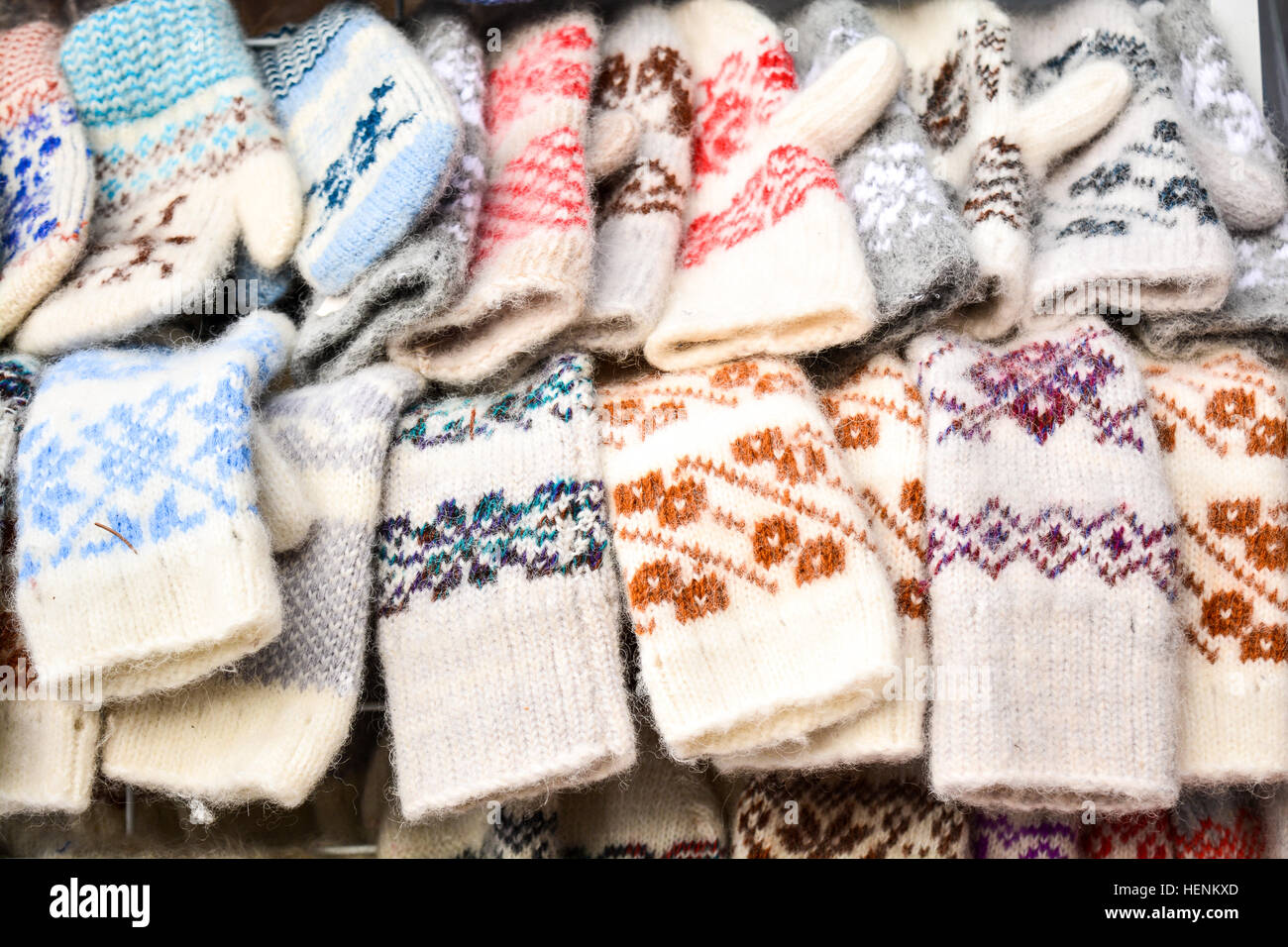 Different hand made wool gloves for winter season at market. Stock Photo