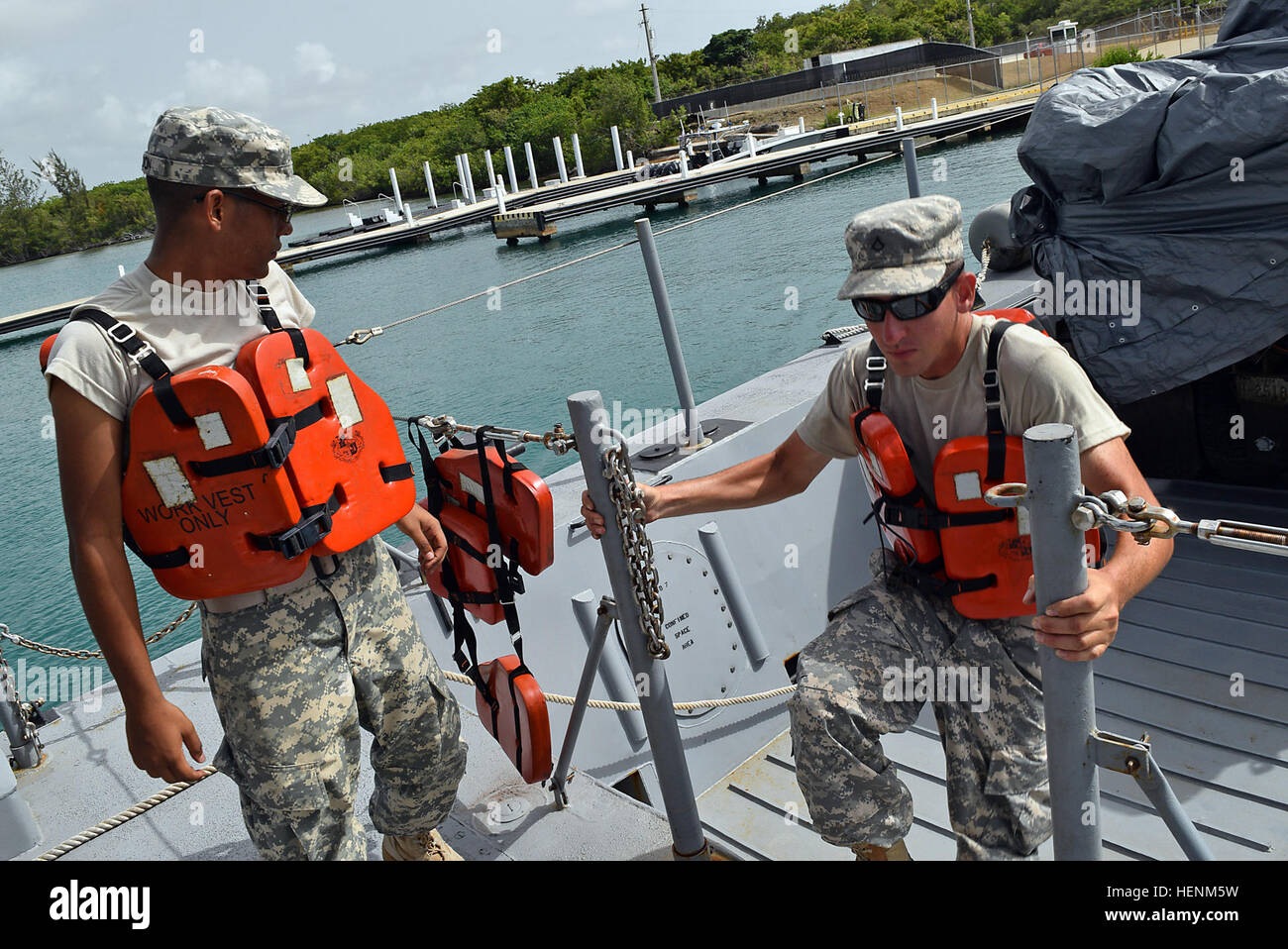 Citizen-Soldiers of the Puerto Rico National Guard assigned to the Landing Craft Detachment, 191st Regional Support Group, navigate aboard a Landing Craft Machine (LCM) to Vieques, Puerto Rico. Pvt. Giorgio Rondon, a 88K watercraft operator, and Pfc. Jose Roque, a 88L watercraft engineer, Sgt. Carlos Seguinot and Sgt. Daniel Acosta, 88K coxswain (captain of the boat), assist in maneuvering the LCM at the port in Ceiba, Puerto Rico, before taking off. (National Guard photo by Sgt. Pablo Pantoja, Joint Force Headquarters Public Affairs, PRNG) Landing Craft Machine takes off to Vieques, Puerto Ri Stock Photo