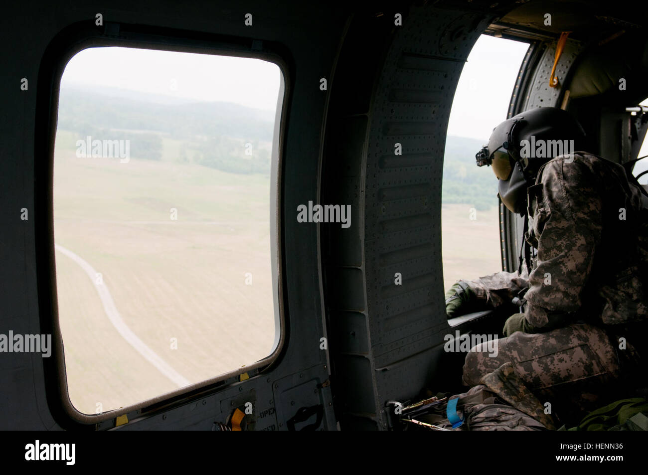 Spc. Kristopher Stovall, a flight medic from the 2nd Battalion, 4th Aviation Regiment, General Support Aviation Battalion, and native of Weatherford, Texas, looks out a window of a UH-60 Black Hawk helicopter during Vibrant Response '14 July 24. Flight medics are the next level of care for patients, after the first responders on the ground. Where first responders apply life-saving aid, flight medics stabilize patients on the helicopter on the way to the hospital. (U.S. Army photo by Staff Sgt. Ray Boyington) VR '14, A view from the top 140724-A-JR267-106 Stock Photo