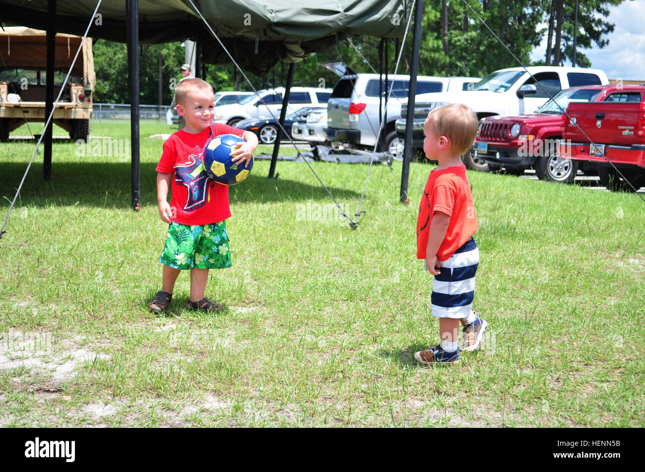 Rowan and Kyler Kilgore, sons of Pfc. Shawn Kilgore, 5th Squadron, 7th Cavalry Regiment, 1st Armored Brigade Combat Team, 3rd Infantry Division, play soccer during the Squadrons Family Day, July 23. (Photo by Sgt. Russell Toof, 1 ABCT, 3rd ID) 5-7 Cav Family Day 140724-A-GJ885-003 Stock Photo