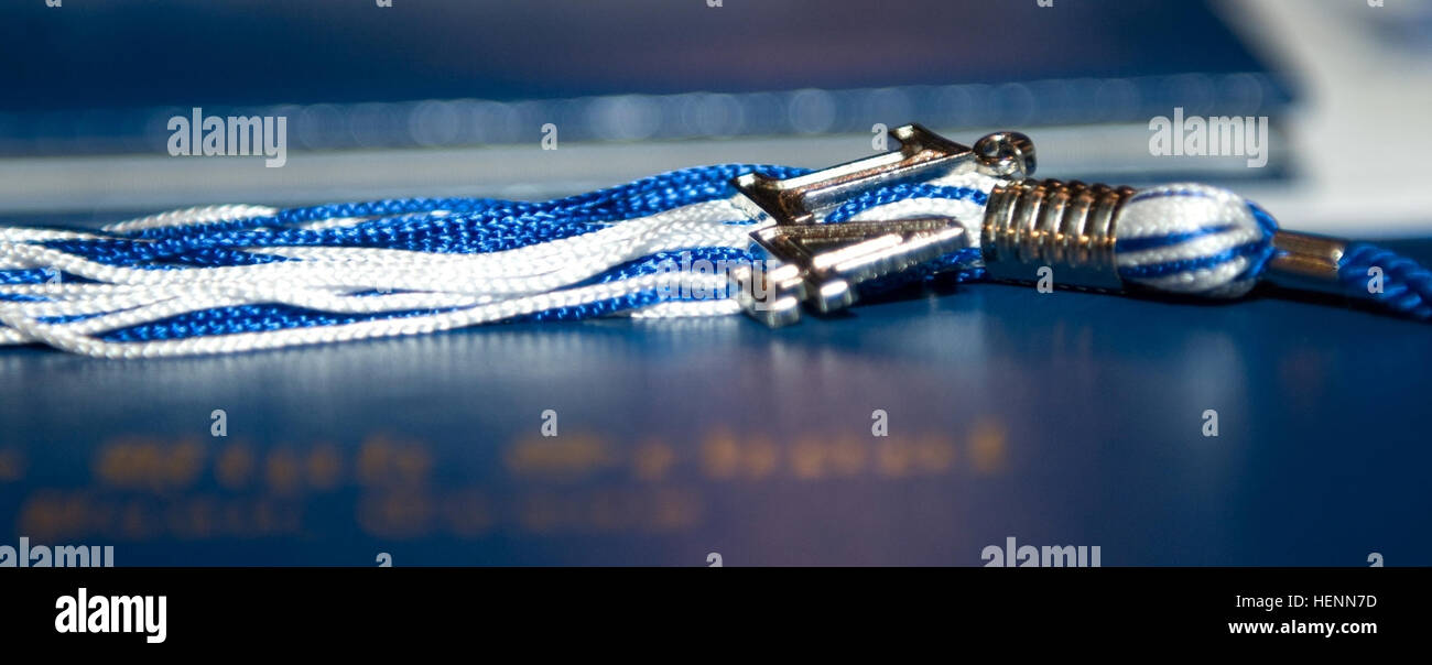 A graduation tassel sits on a diploma at the graduation ceremony for WWII veterans held at Bowie High School, El Paso, Texas July 25, 2014. The veterans were all members of Company E, 2nd Battalion, 141st Infantry Regiment of the 36th Texas Division, 5th Army. (U.S. Army photo by Sgt. Jarred Woods, 16th Mobile Public Affairs Detachment) WWII veterans receive long awaited honor 140725-A-ZA744-012 Stock Photo