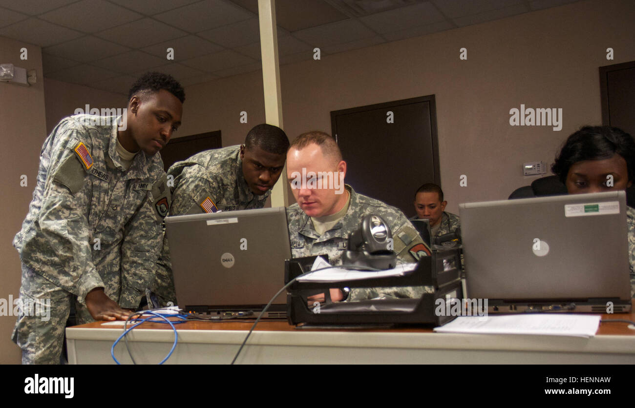 Task Force Joint Reconnaissance Center Army Reserve Soldiers (left to right) Pfc. Louis Matthews, Pfc. Dwight Wells, Sgt. 1st Class Brandon K. Drzymalla and Spc. Jasmine Holmes streamline in-processing operations at Vibrant Response 14 at Camp Atterbury Joint Maneuver Training Center, Ind., July 30. The Soldiers are assigned to the 328th Human Resources Company at Fort Sam Houston. Vibrant Response is a U.S. Northern Command-sponsored field training exercise for chemical, biological, radiological, nuclear and high-yield explosive consequence management forces designed to improve their ability  Stock Photo