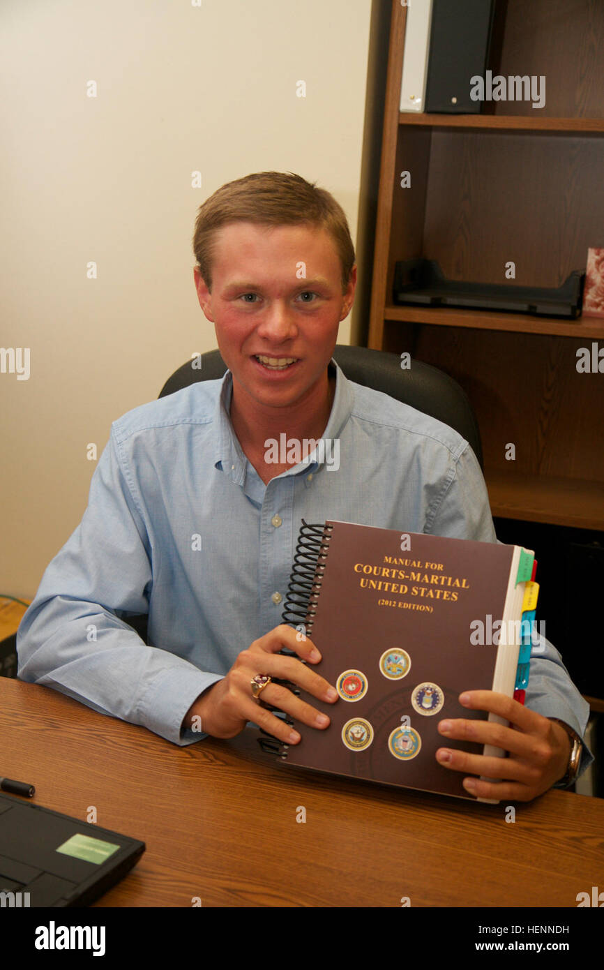 Parker Gochenour displays the United States Manual for Courts-Martial while interning with the 1st Cavalry Division's Office of Judge Advocate at Fort Hood, ...